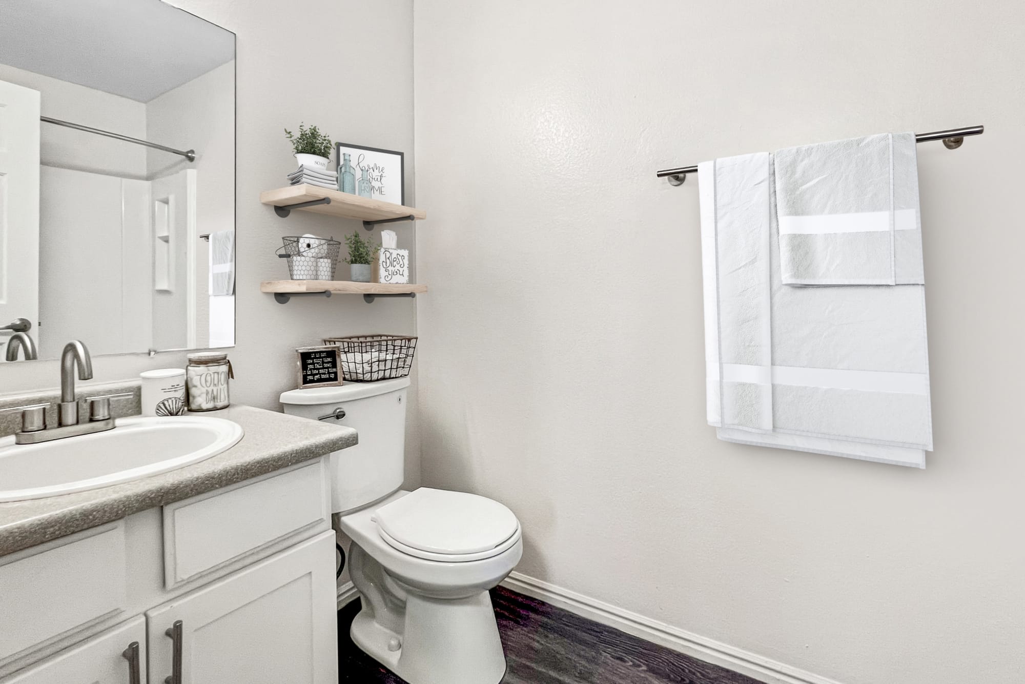 Newly Renovated Bathroom with White Cabinets at Shadowbrook Apartments in West Valley City, Utah