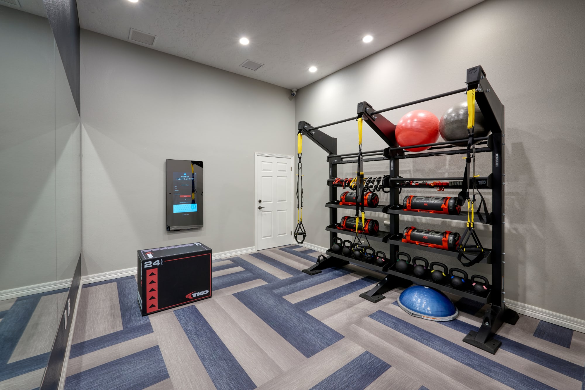 Fitness Room with TRX Bands and Weights at Promenade at Hunter's Glen Apartments in Thornton, Colorado