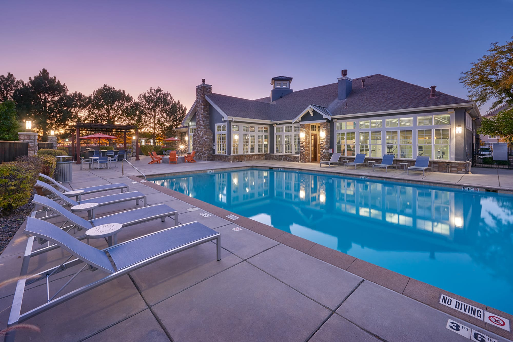 Pool shot with clubhouse and firepit  at Crestone Apartments in Aurora, Colorado