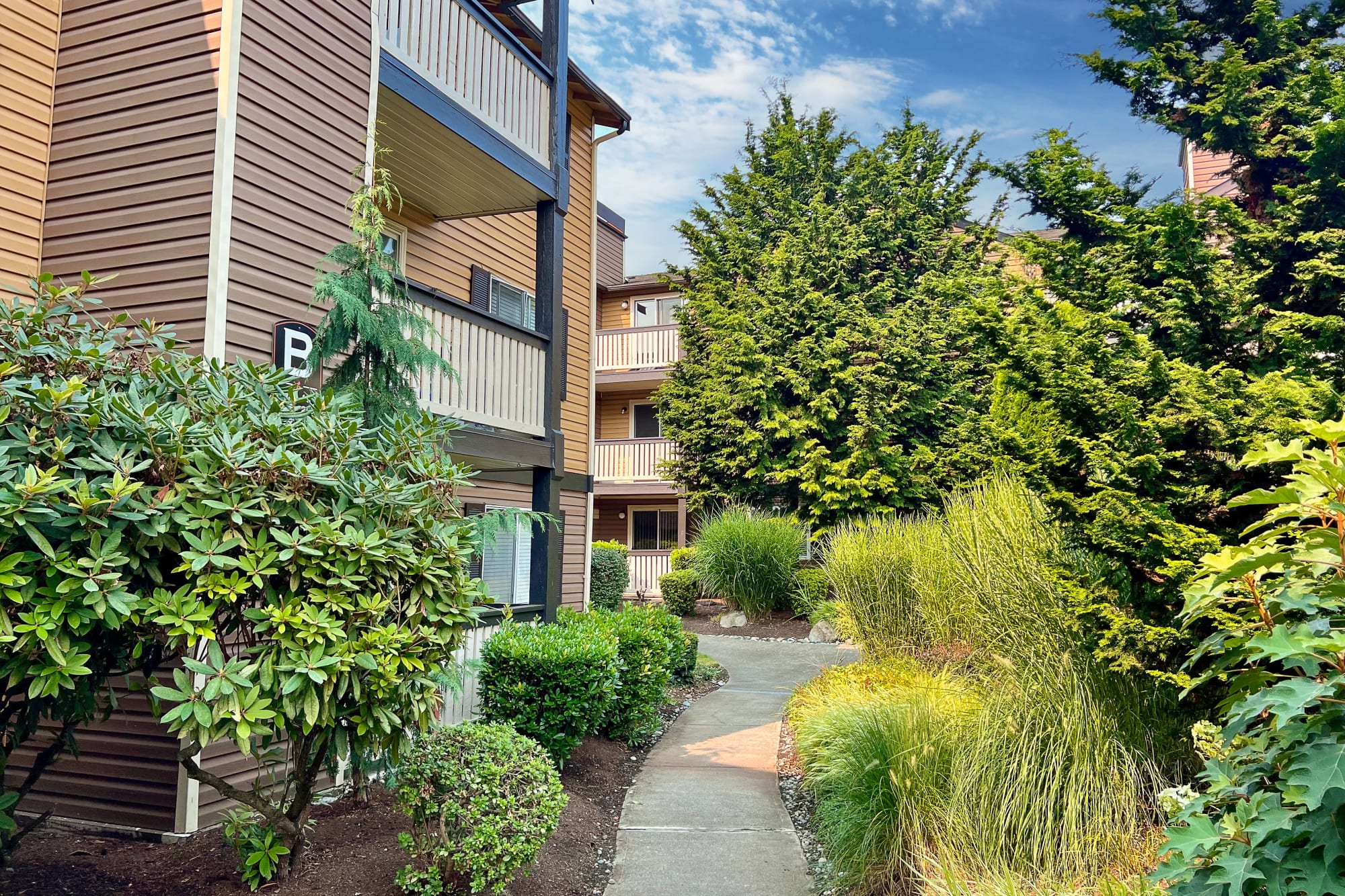 Beautifully landscaped exterior view of property at Newport Crossing Apartments in Newcastle, Washington