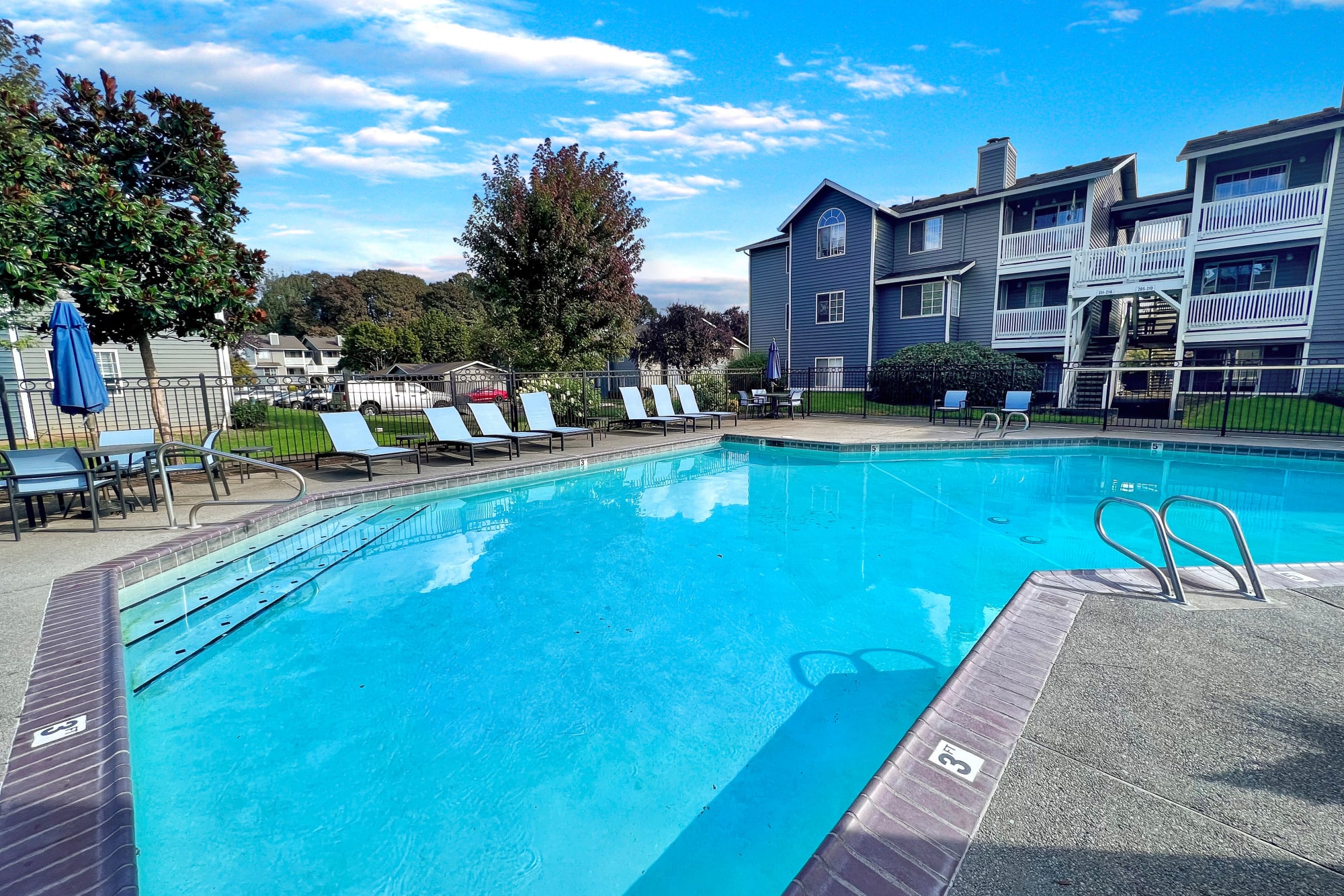 Sparkling pool with new lounge chairs at Walnut Grove Landing Apartments in Vancouver, Washington