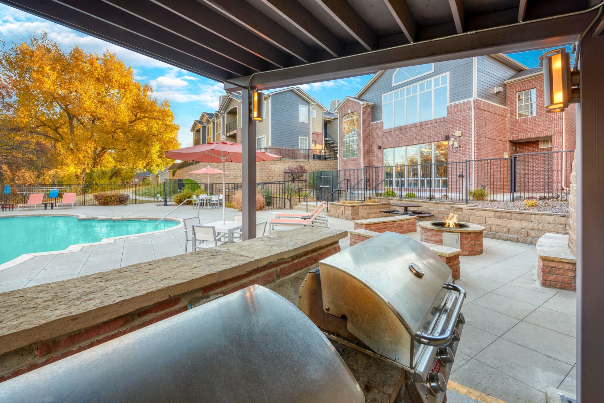 The poolside covered outdoor BBQs at The Crossings at Bear Creek Apartments in Lakewood, Colorado