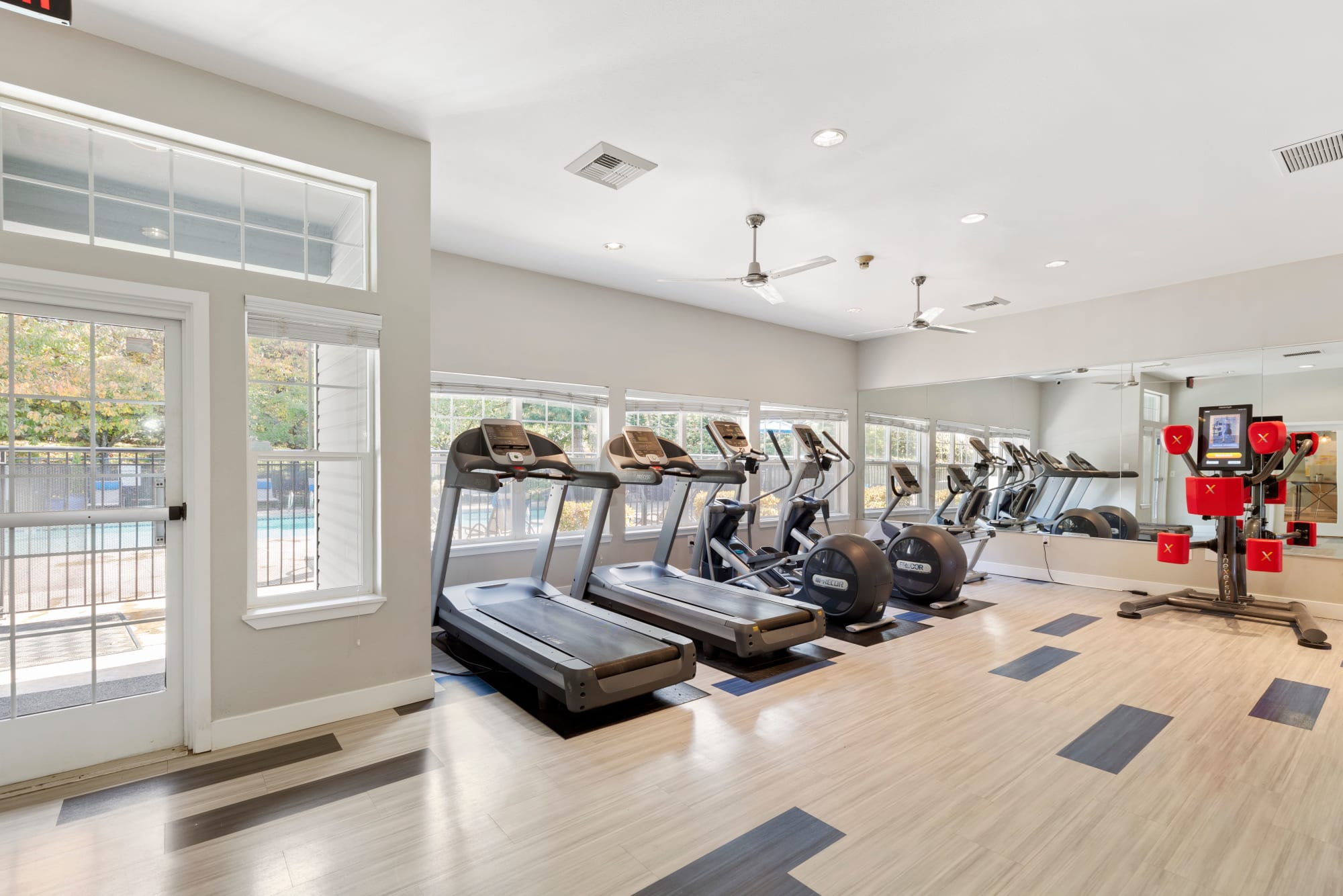 Fitness center with boxing and cardio machines at Pebble Cove Apartments in Renton, Washington