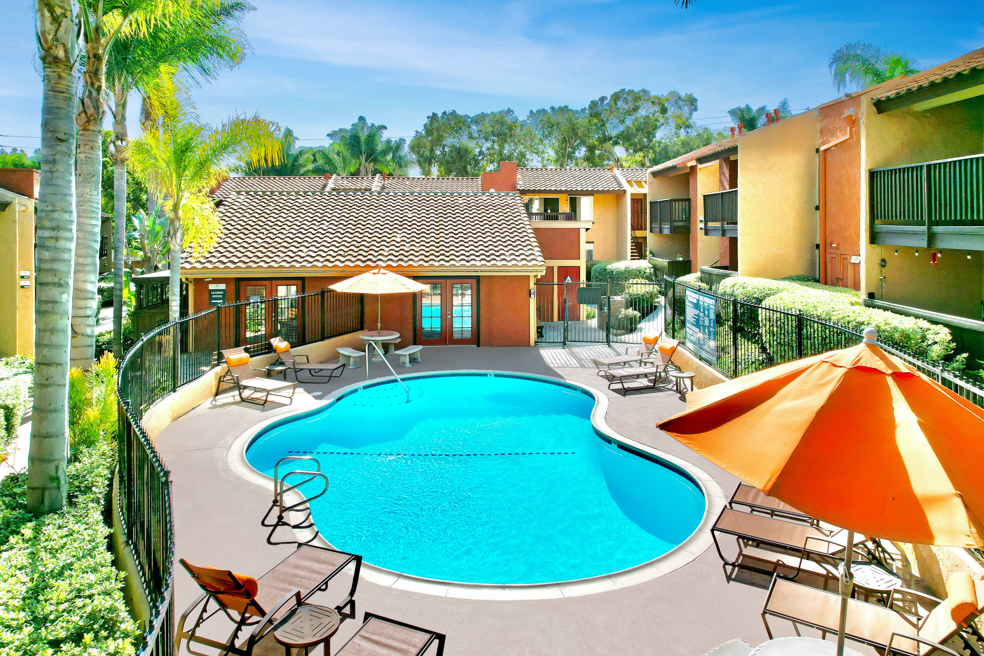Pool with lounge chairs at Shadow Ridge Apartments in Oceanside, California