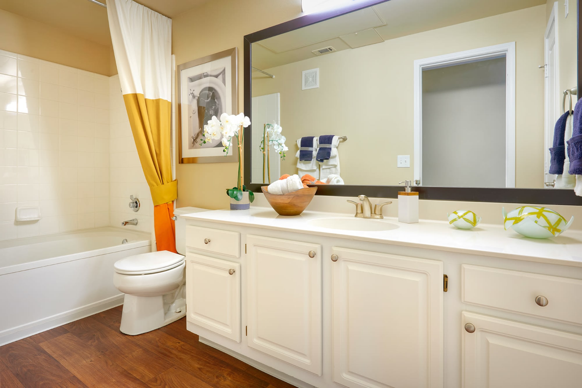 Bathroom with a large vanity mirror at Legend Oaks Apartments in Aurora, Colorado