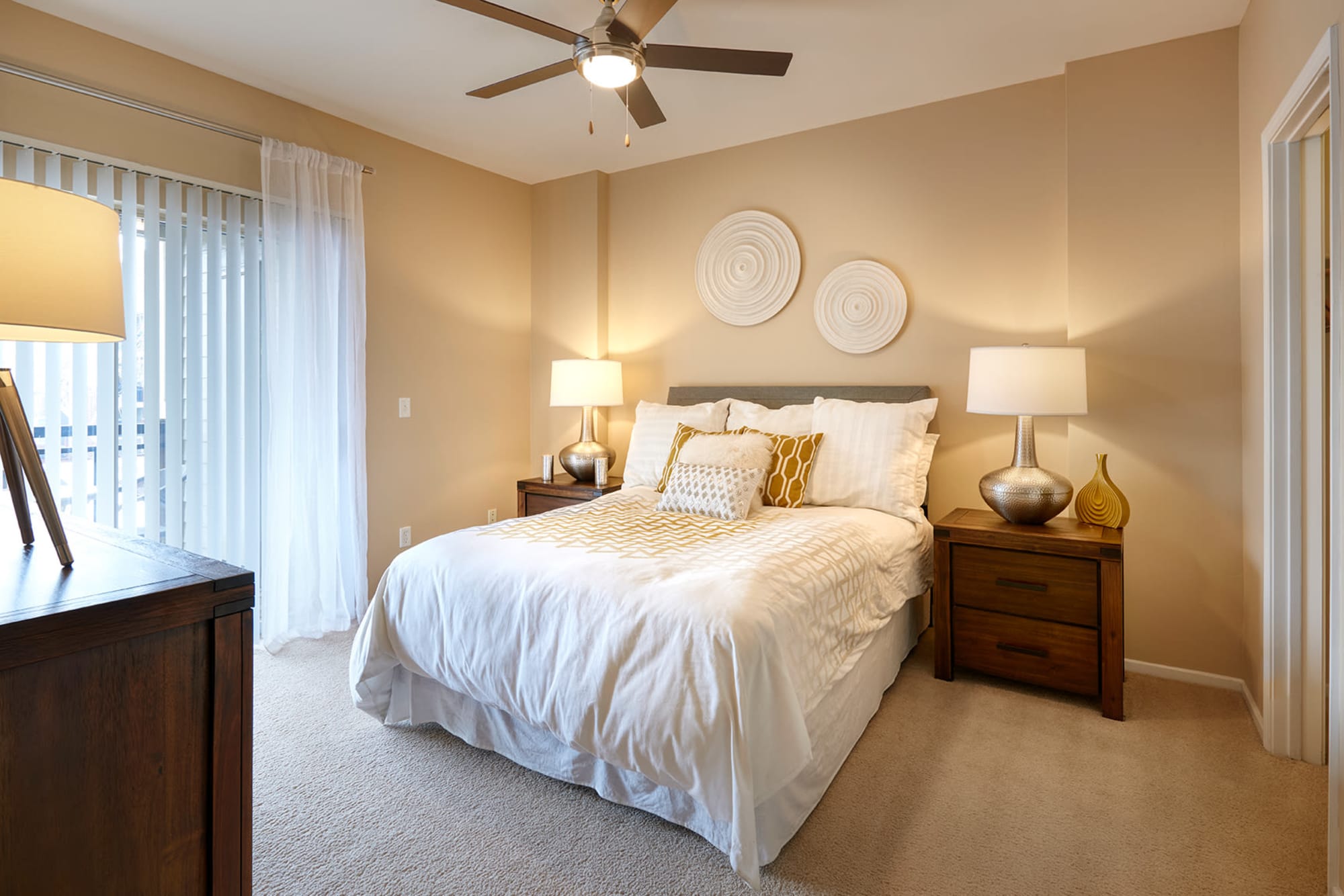 Master bedroom with a ceiling fan at Legend Oaks Apartments in Aurora, Colorado