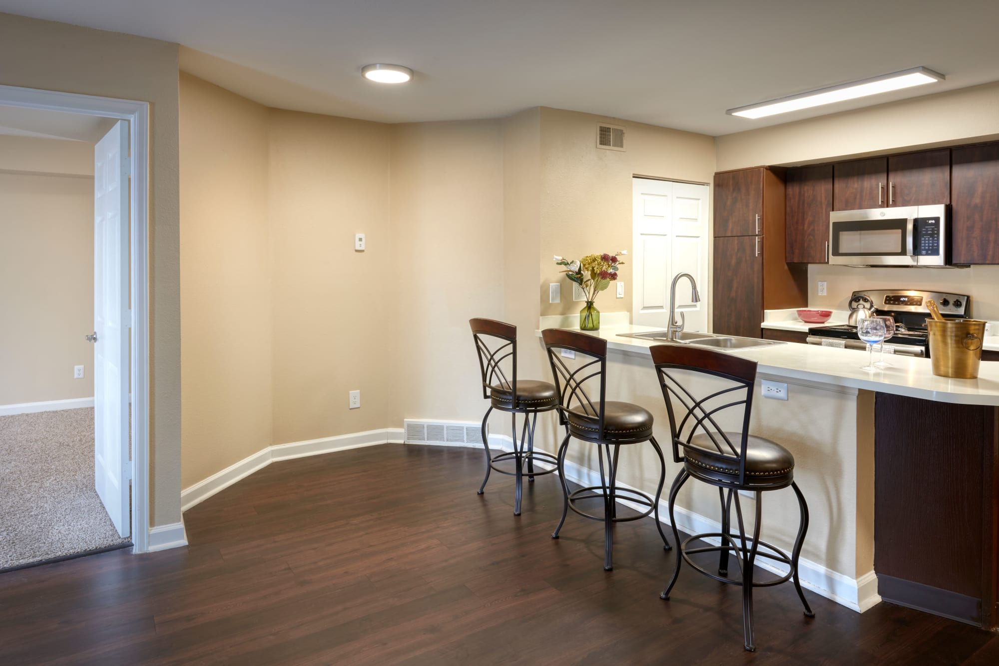 Renovated kitchen with brown cabinets at Villas at Homestead Apartments in Englewood, Colorado