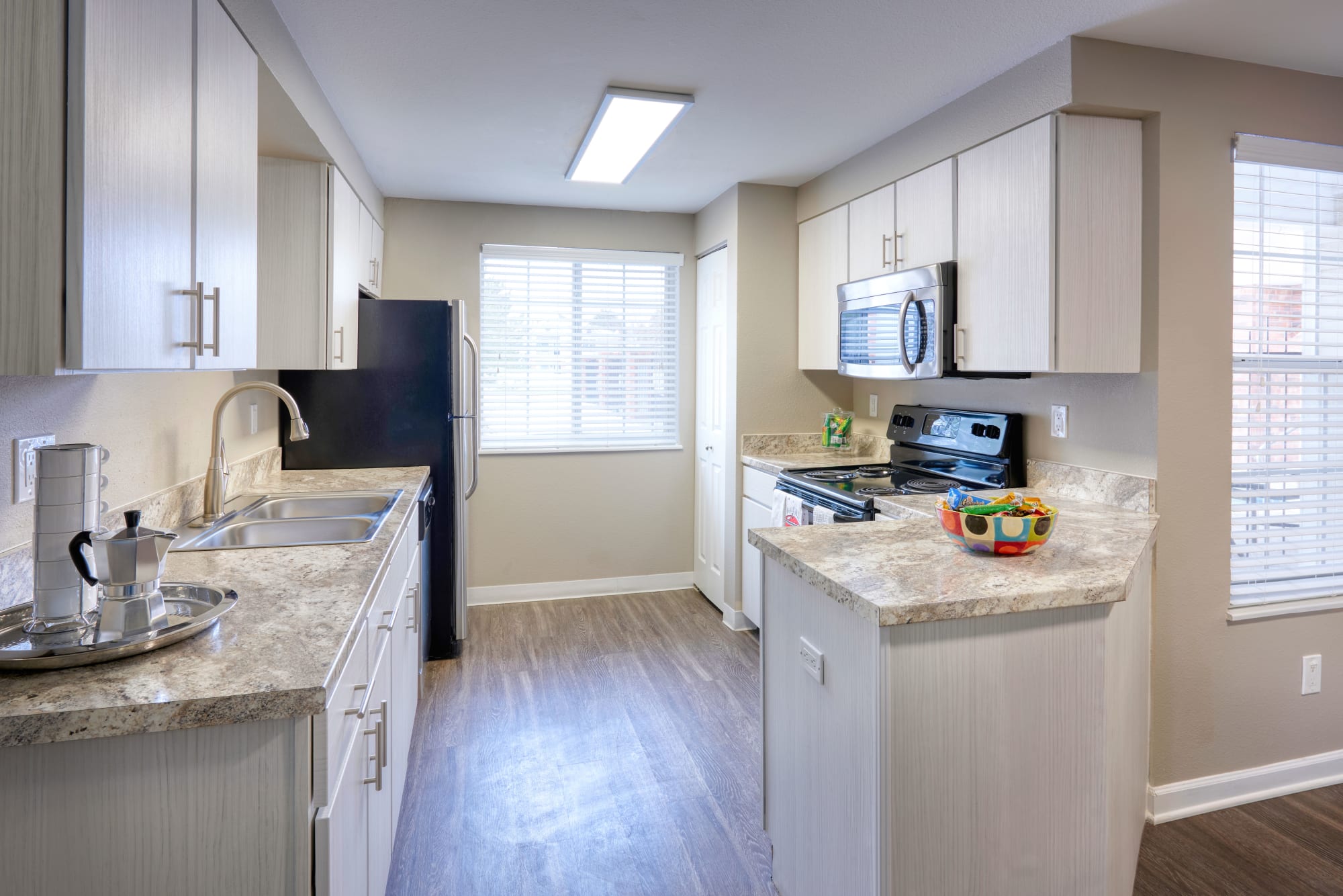 Well organized kitchen in an open floor plan at Villas at Homestead Apartments in Englewood, Colorado