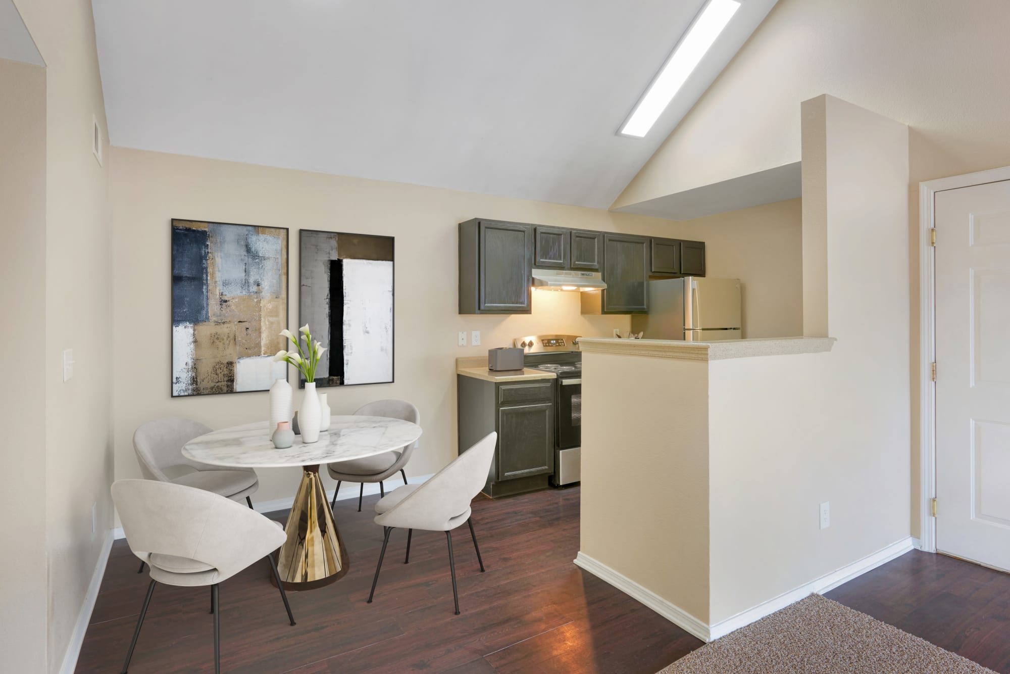 Kitchen and dining room at Crossroads at City Center Apartments in Aurora, Colorado
