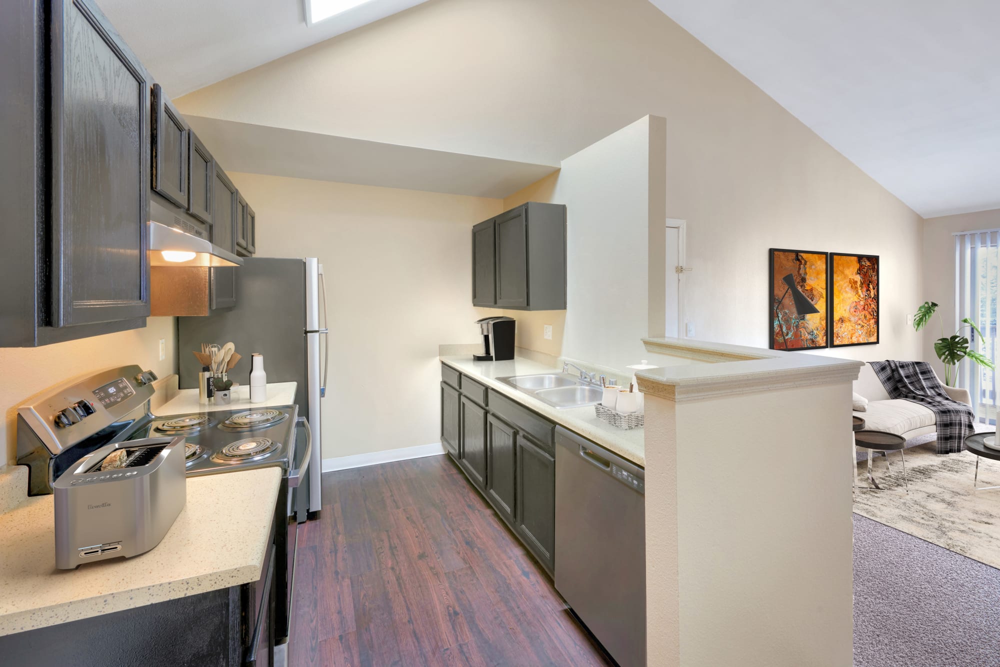 Kitchen and living room at Crossroads at City Center Apartments in Aurora, Colorado