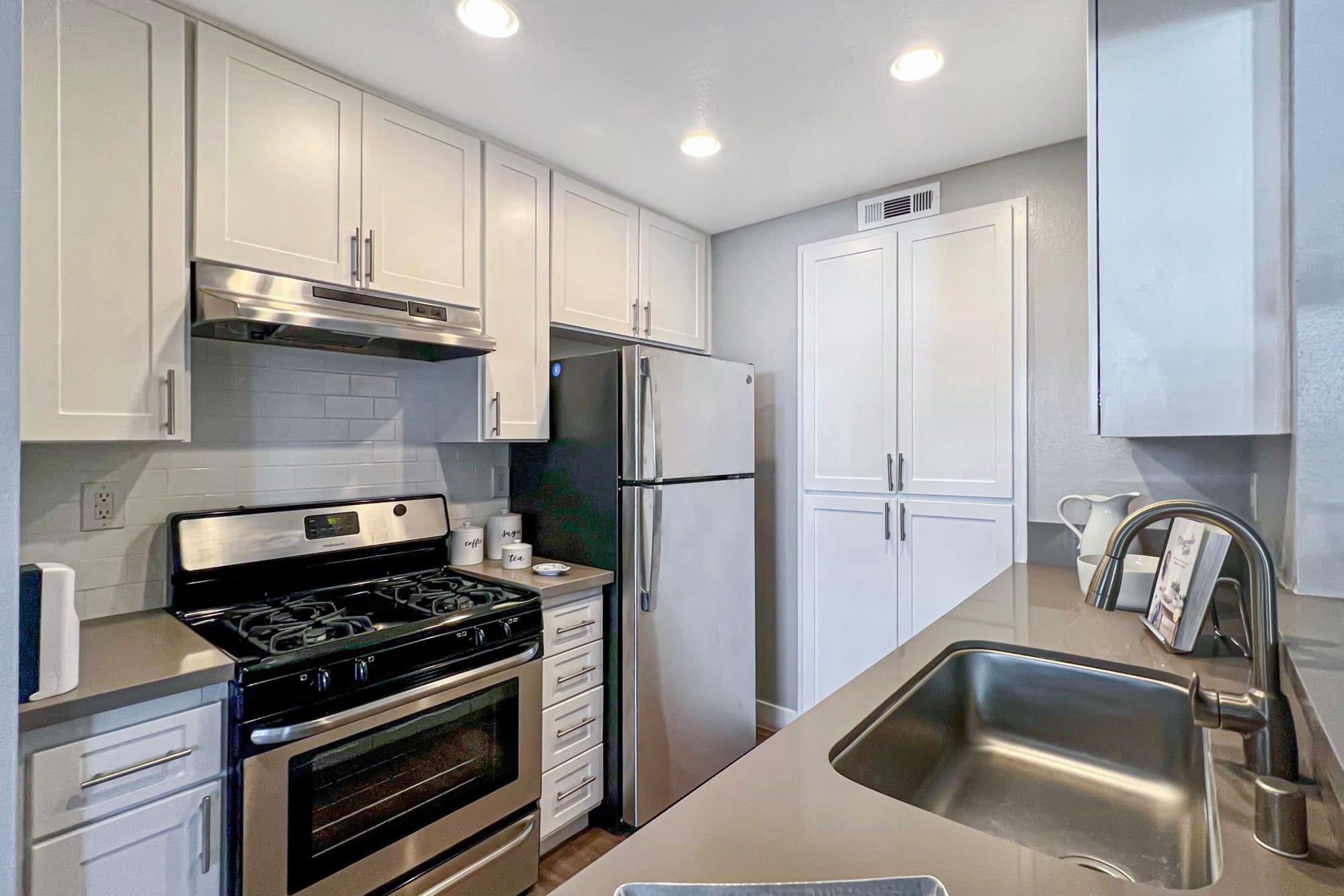 A kitchen with stainless-steel appliances at Portofino Townhomes in Wilmington, California