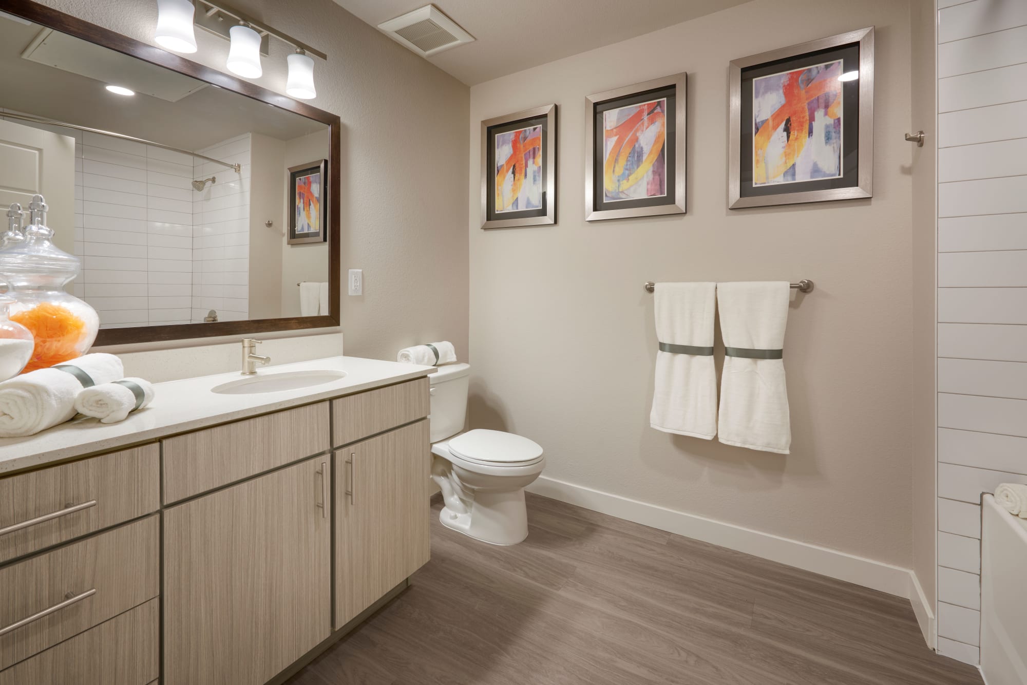 Bathroom with large vanity mirror at Strata Apartments in Denver, Colorado