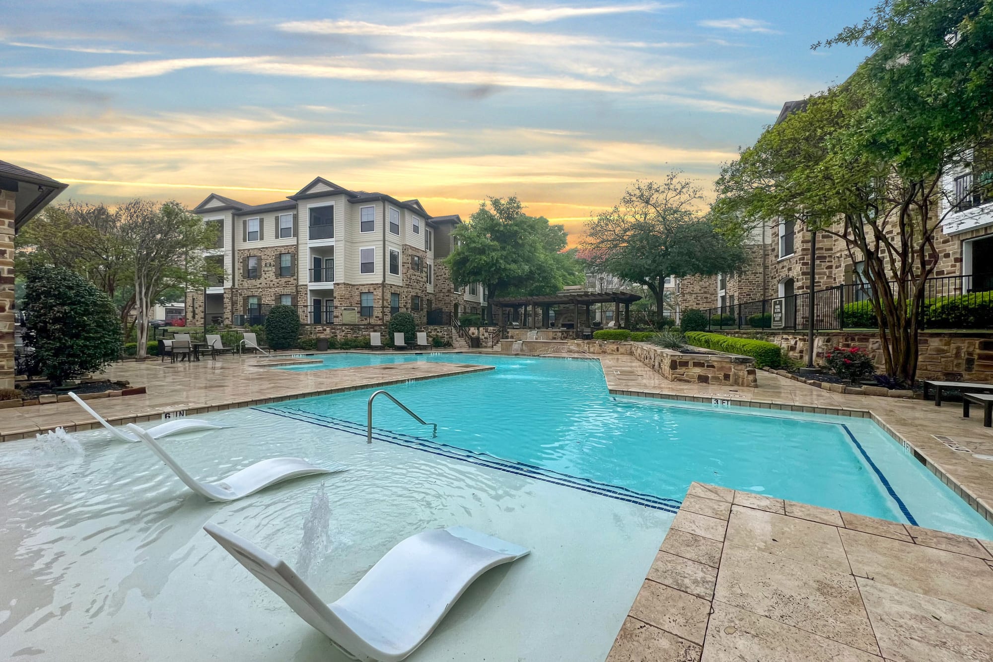 The sparkling swimming pool on a sunny day at Broadstone Grand Avenue in Pflugerville, Texas