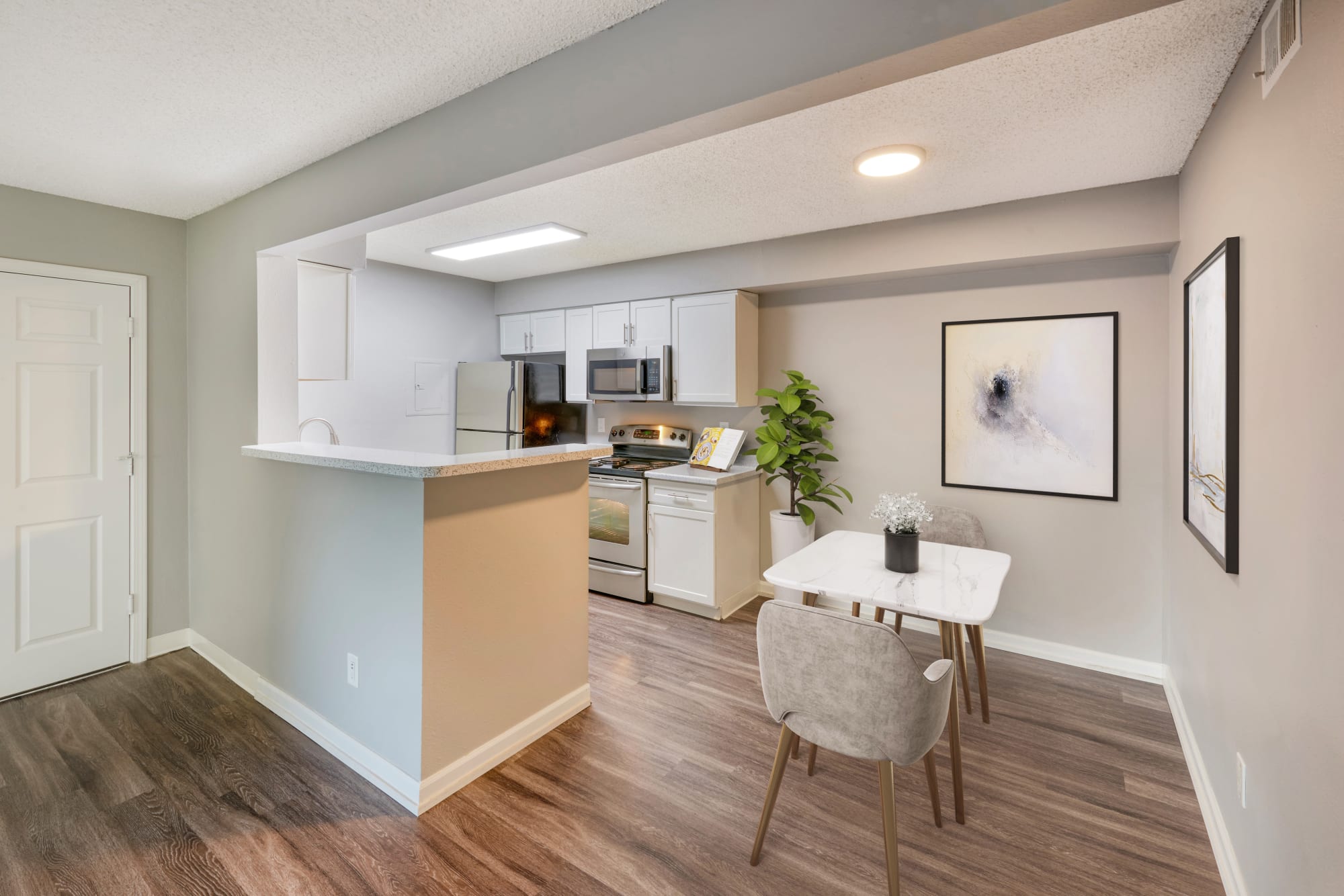 Modern white cabinets in kitchens at Alton Green Apartments in Denver, Colorado