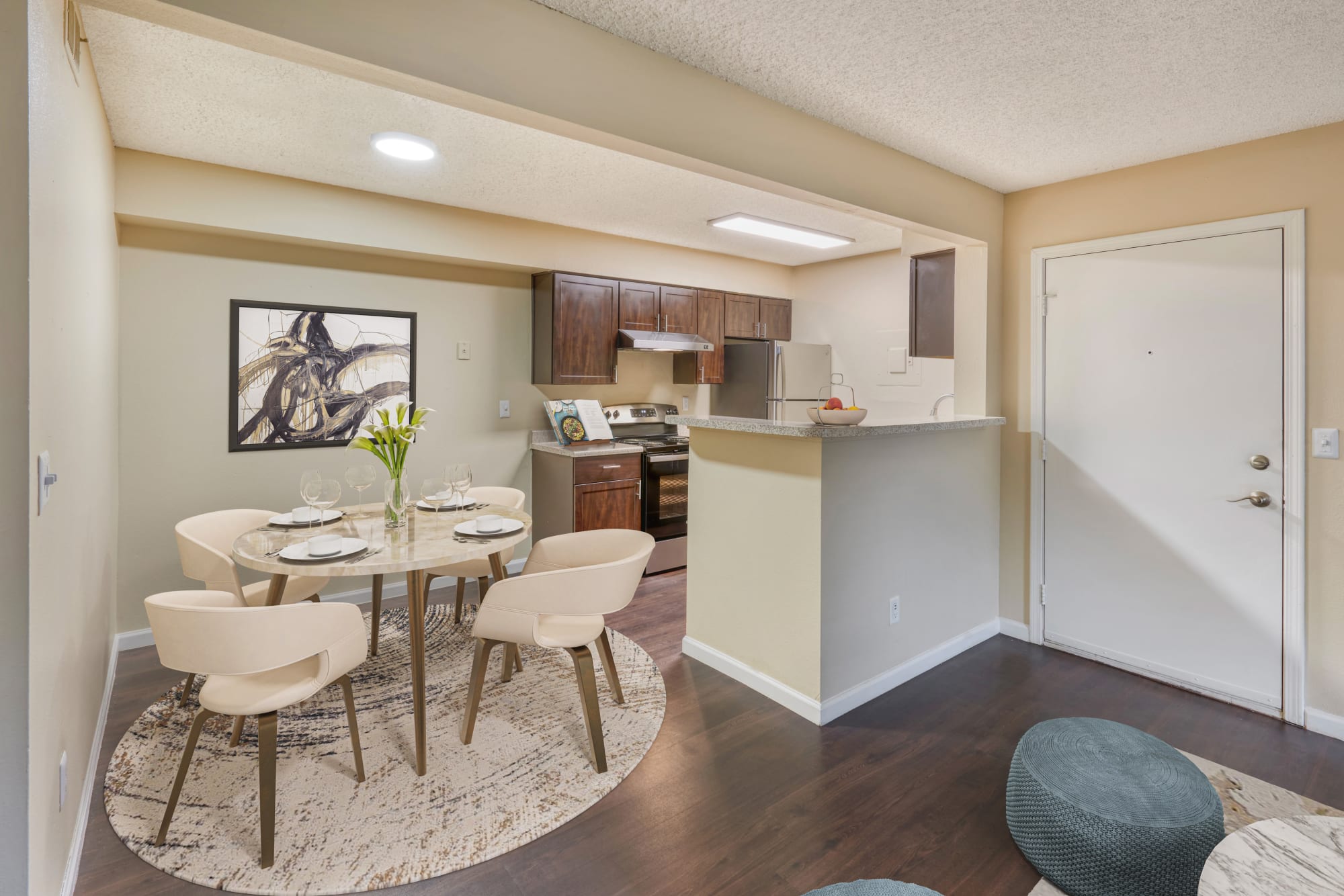 Kitchen and dining room with brown accents and espresso cabinets at Alton Green Apartments in Denver, Colorado