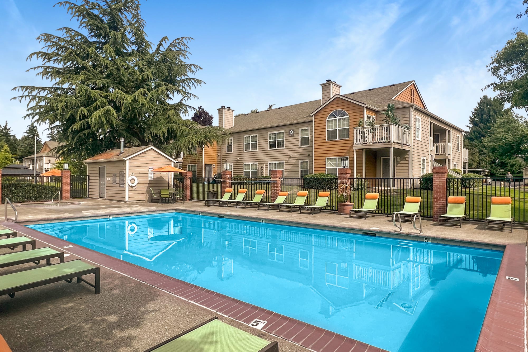 Lounge chairs by the pool at Carriage Park Apartments in Vancouver, Washington