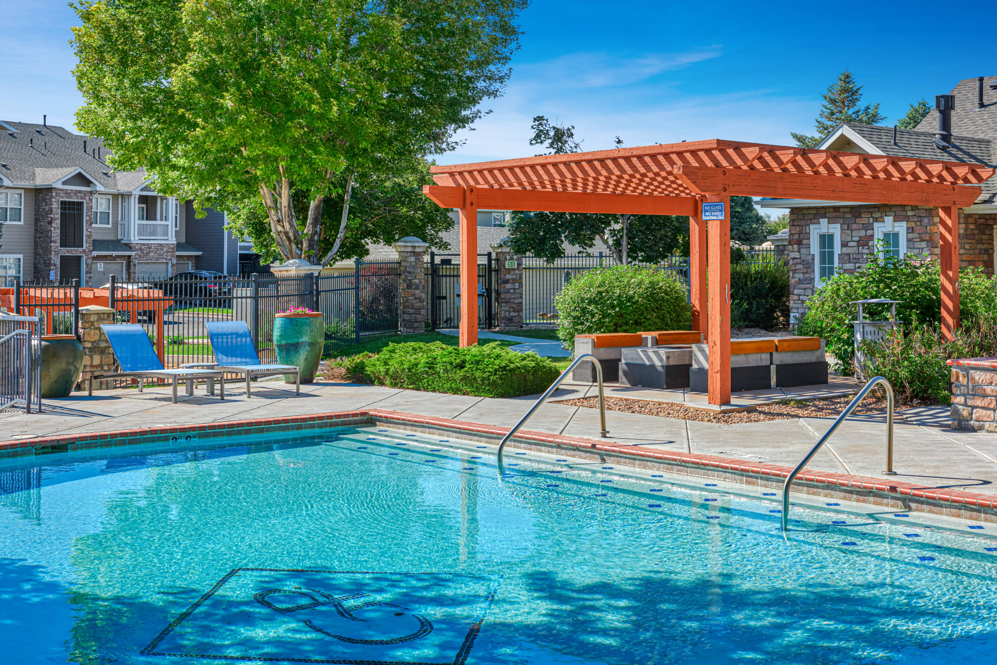 Poolside lounge area with a fire pit at Gateway Park Apartments in Denver, Colorado