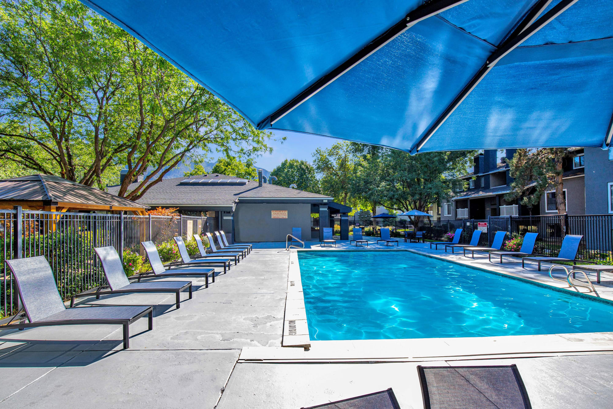 Pool with lounge chairs at Royal Farms Apartments in Salt Lake City, Utah