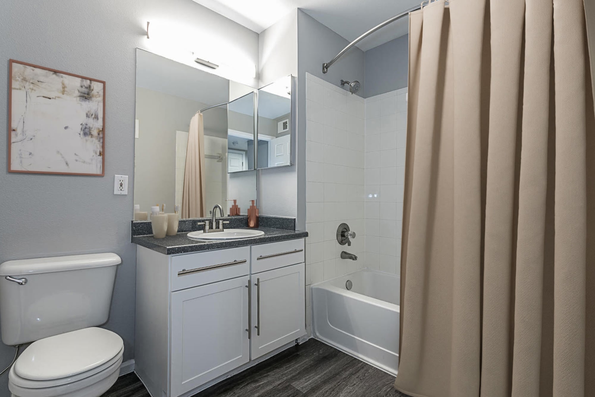 Renovated Bathroom with White Cabinetry at Tuscany Village Apartments in Ontario, California