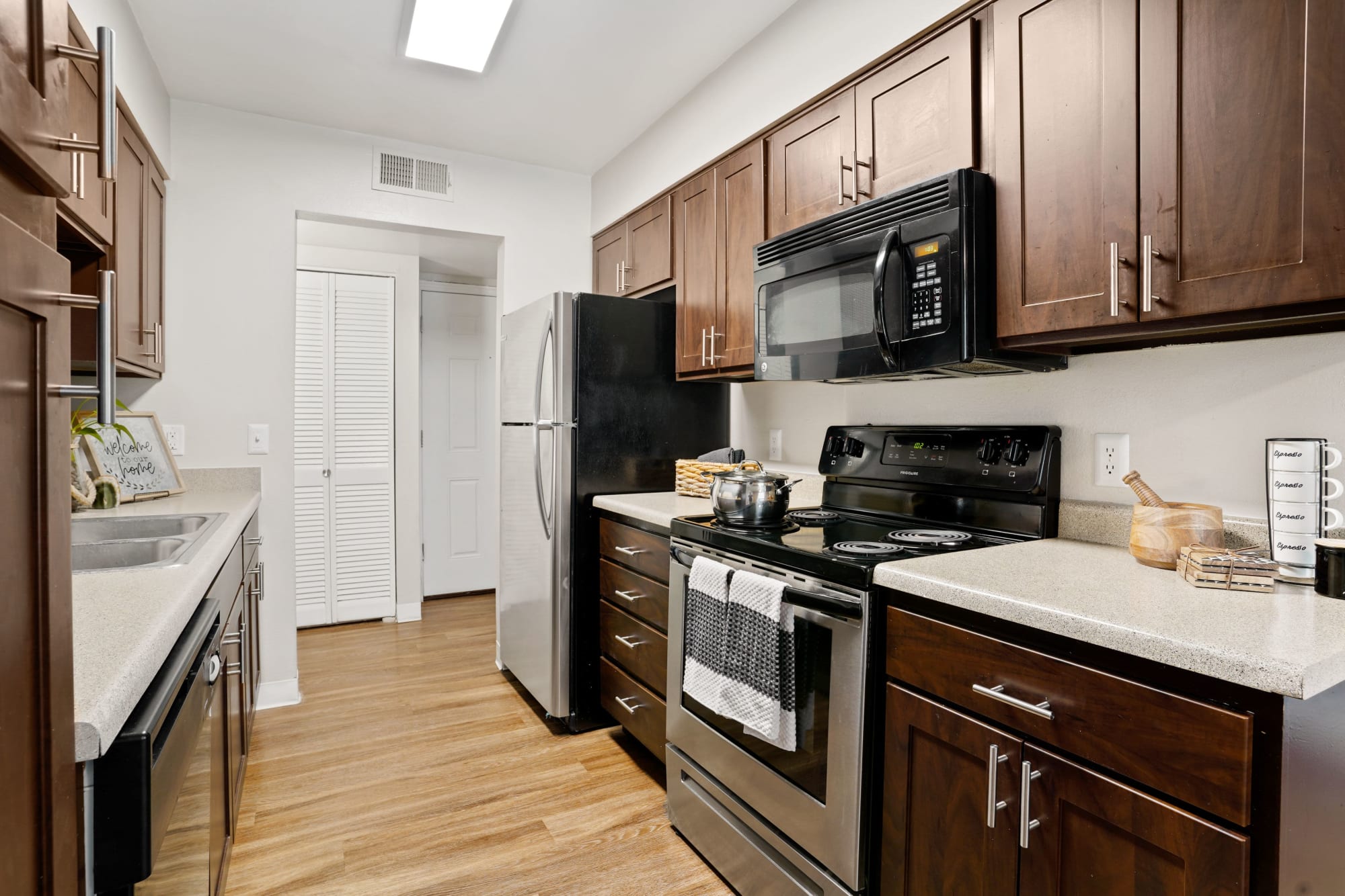Renovated brown kitchen with stainless steel appliances at Royal Ridge Apartments in Midvale, Utah