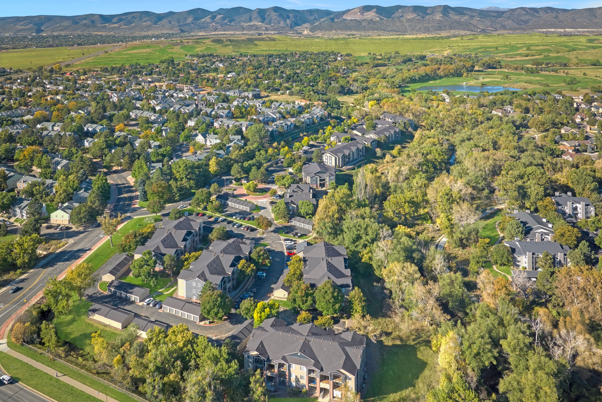 An aerial view of the property and surrounding areas at The Crossings at Bear Creek Apartments in Lakewood, Colorado