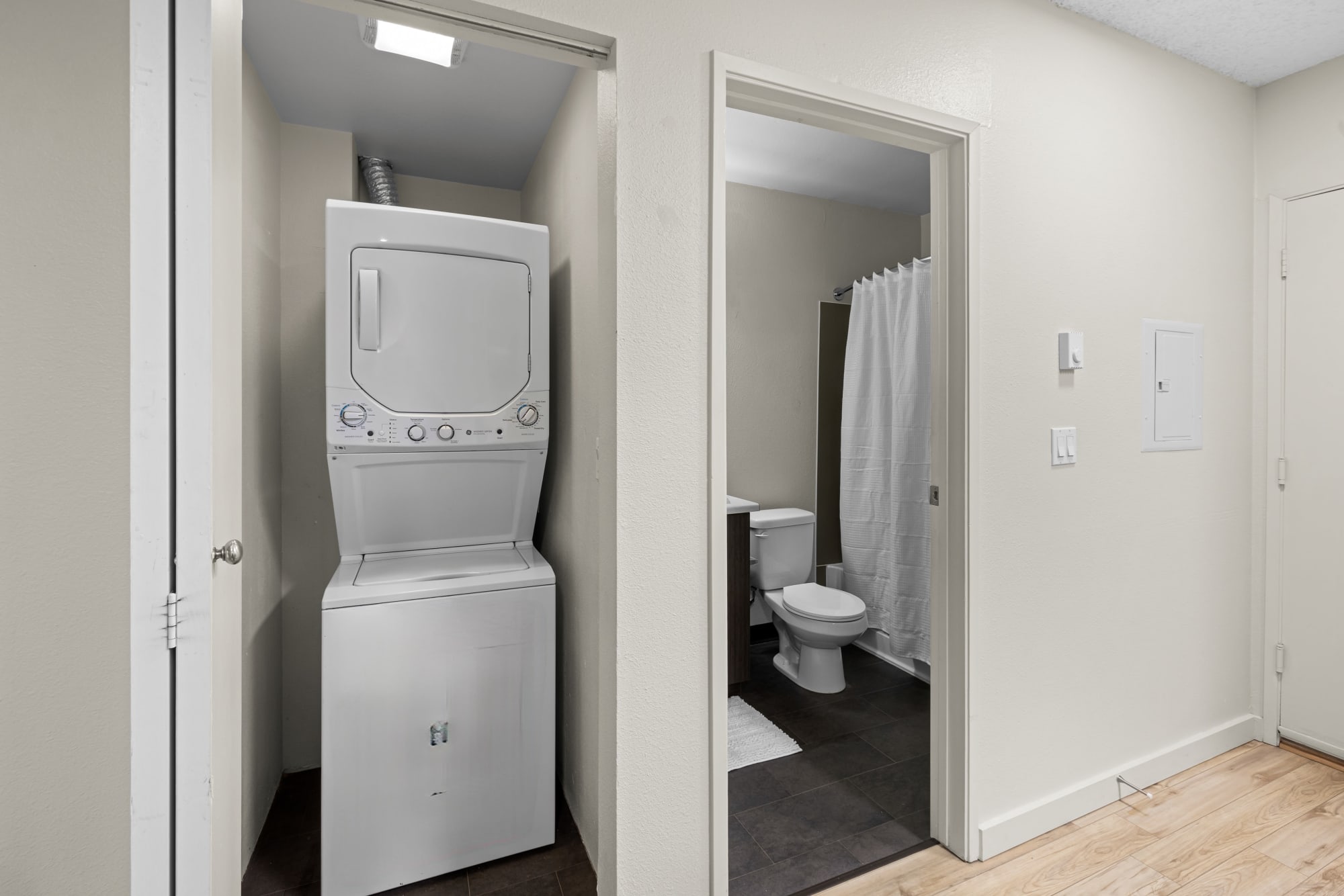 Bathroom and stacked washer and dryer at Karbon Apartments in Newcastle, Washington