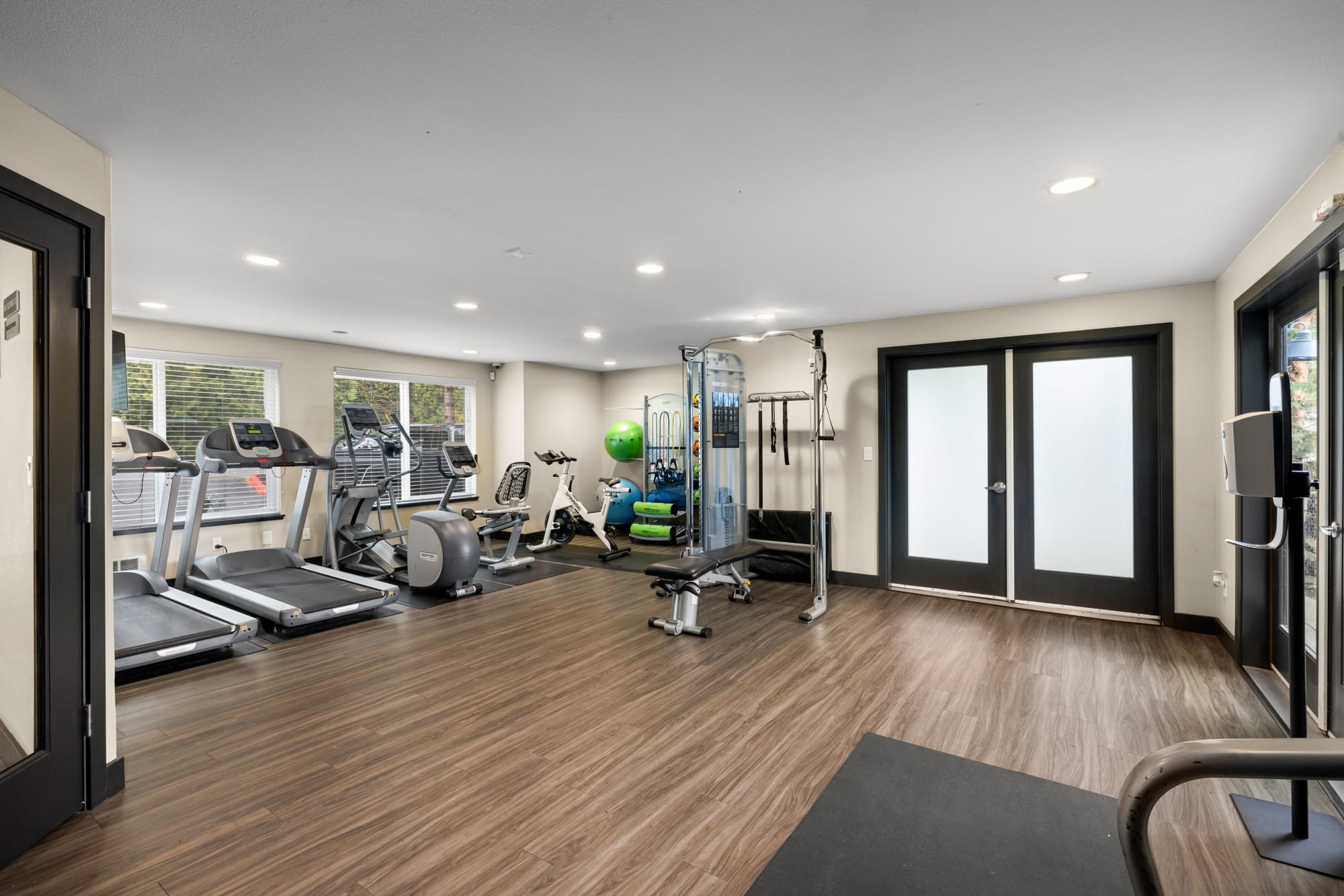 Newly renovated fitness center with free weights at Karbon Apartments in Newcastle, Washington