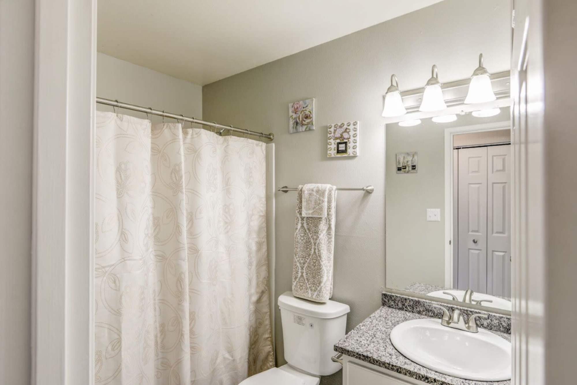 Modern bathroom with granite countertops at Ascent at Havana in Denver, Colorado