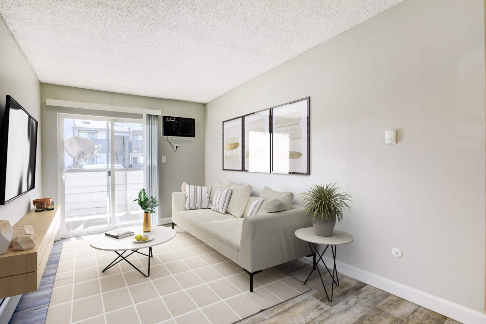 A furnished apartment living room with a sliding door to the patio at Ascent at Lowry in Denver, Colorado