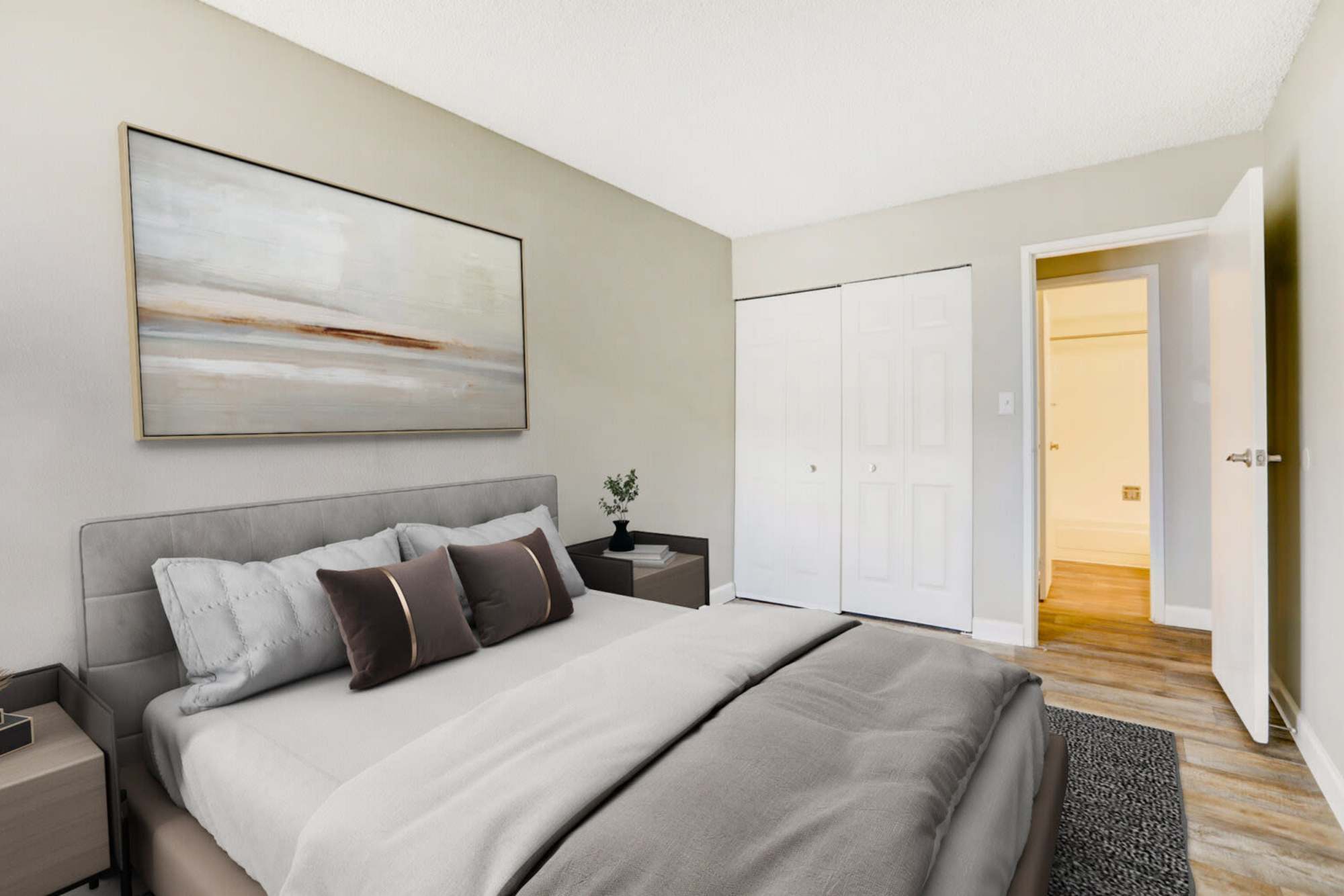 A king-sized bed in a model apartment bedroom at Ascent at Lowry in Denver, Colorado