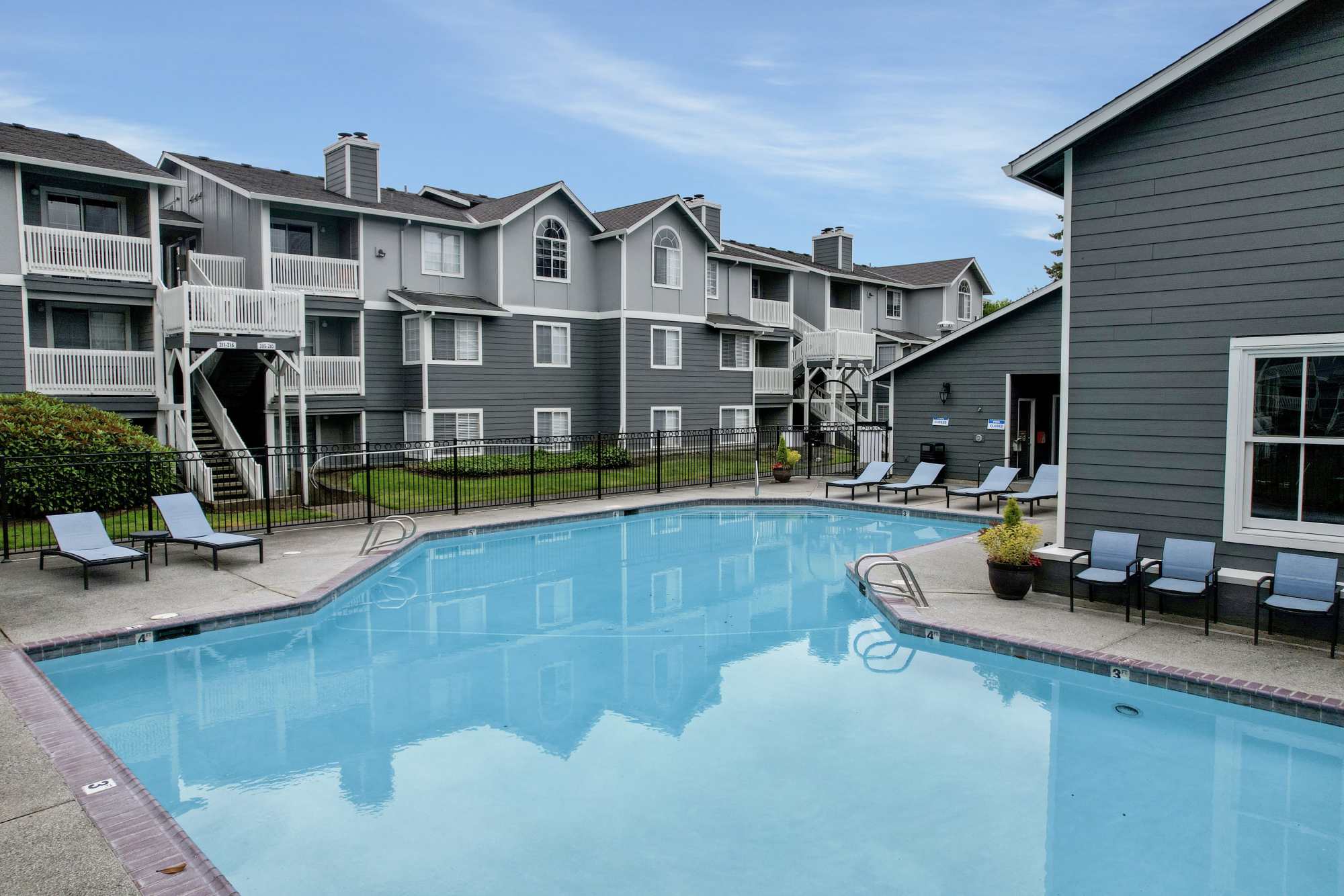 Sparkling pool with new lounge chairs at Walnut Grove Landing Apartments in Vancouver, Washington