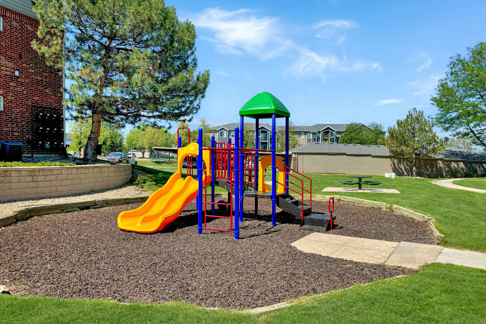 Playground and open landscaping at Promenade at Hunter's Glen Apartments in Thornton, Colorado