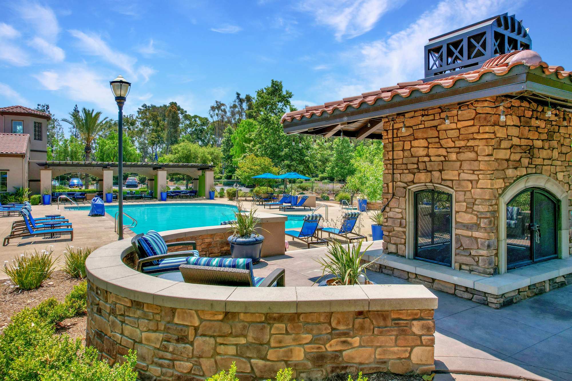 Large outdoor firepit lounge poolside at Palisades Sierra Del Oro in Corona, California