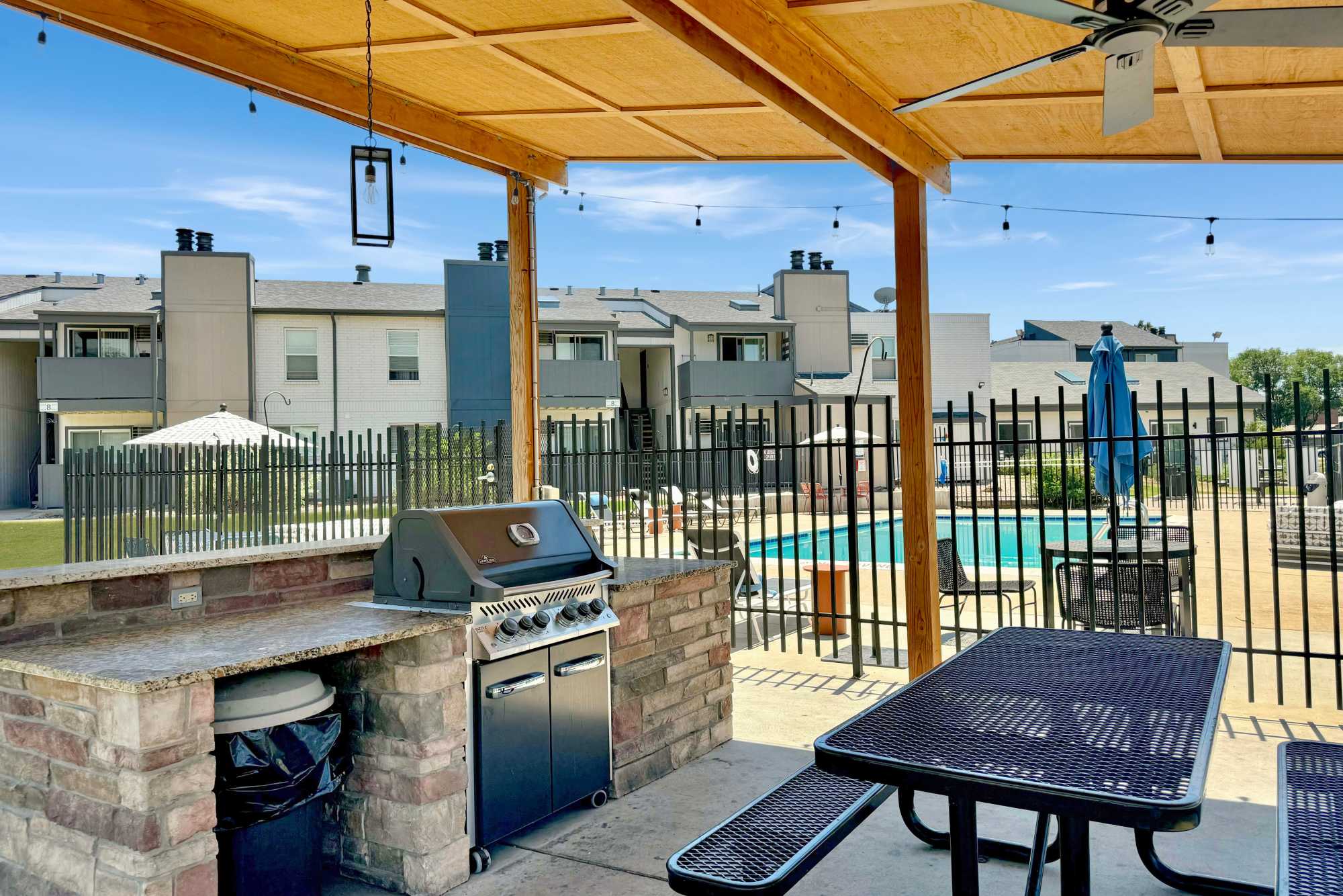 Grilling area surrounded by lush green grass at Ascent at Lowry in Denver, Colorado