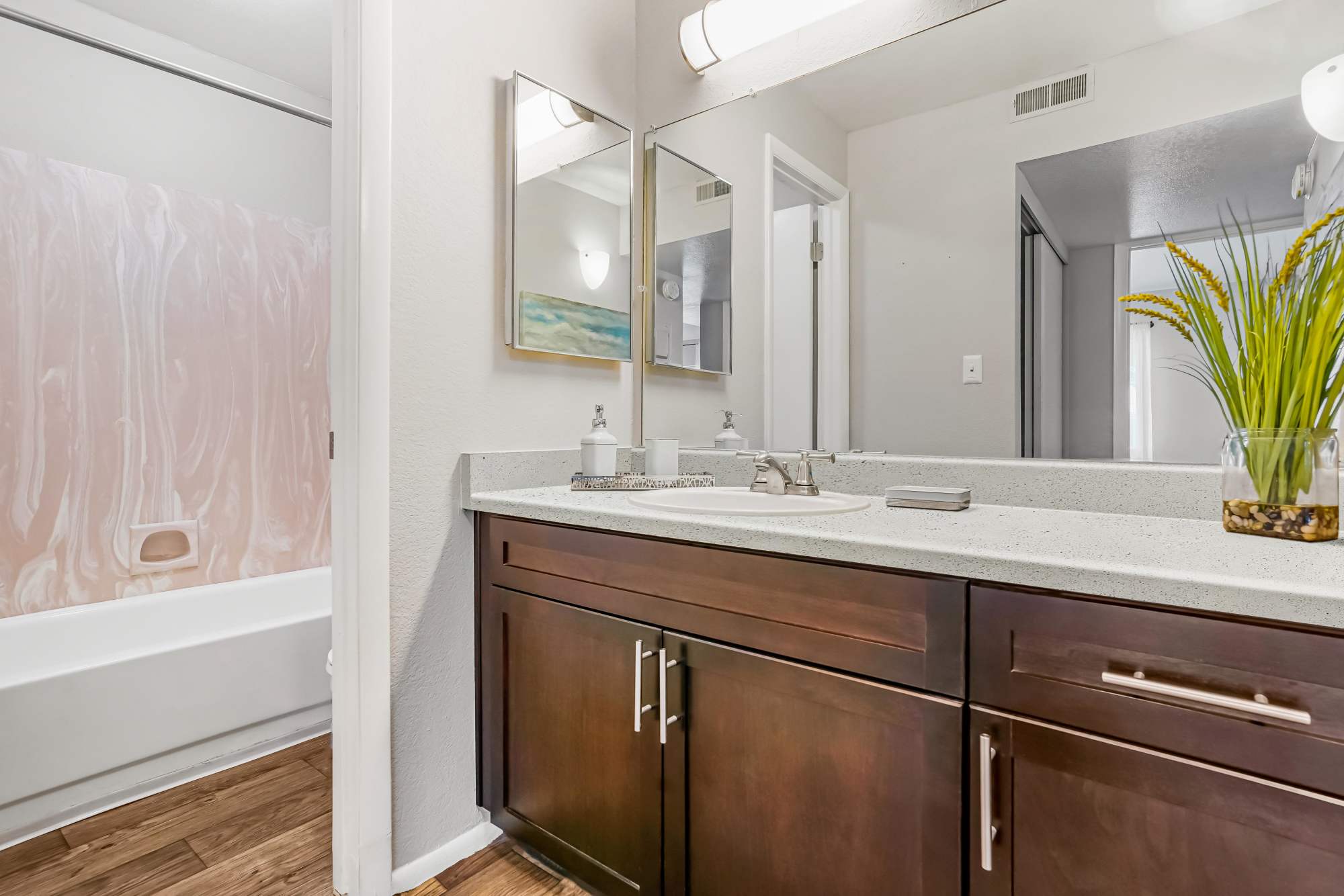 Ample counter space and a large mirror in a bathroom at Callaway Apartments in Taylorsville, Utah