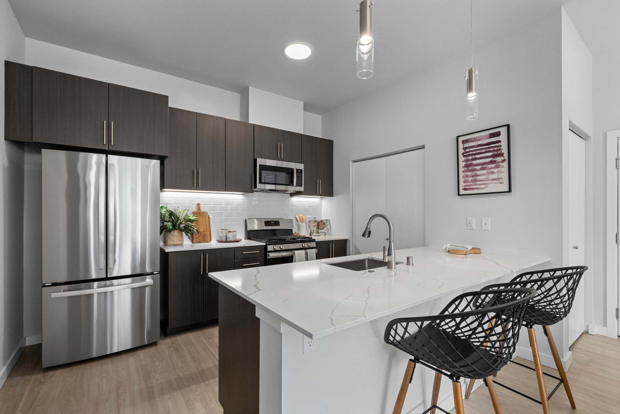 Kitchen with Brown Cabinets and Island at The Highlands at Silverdale in Silverdale, Washington