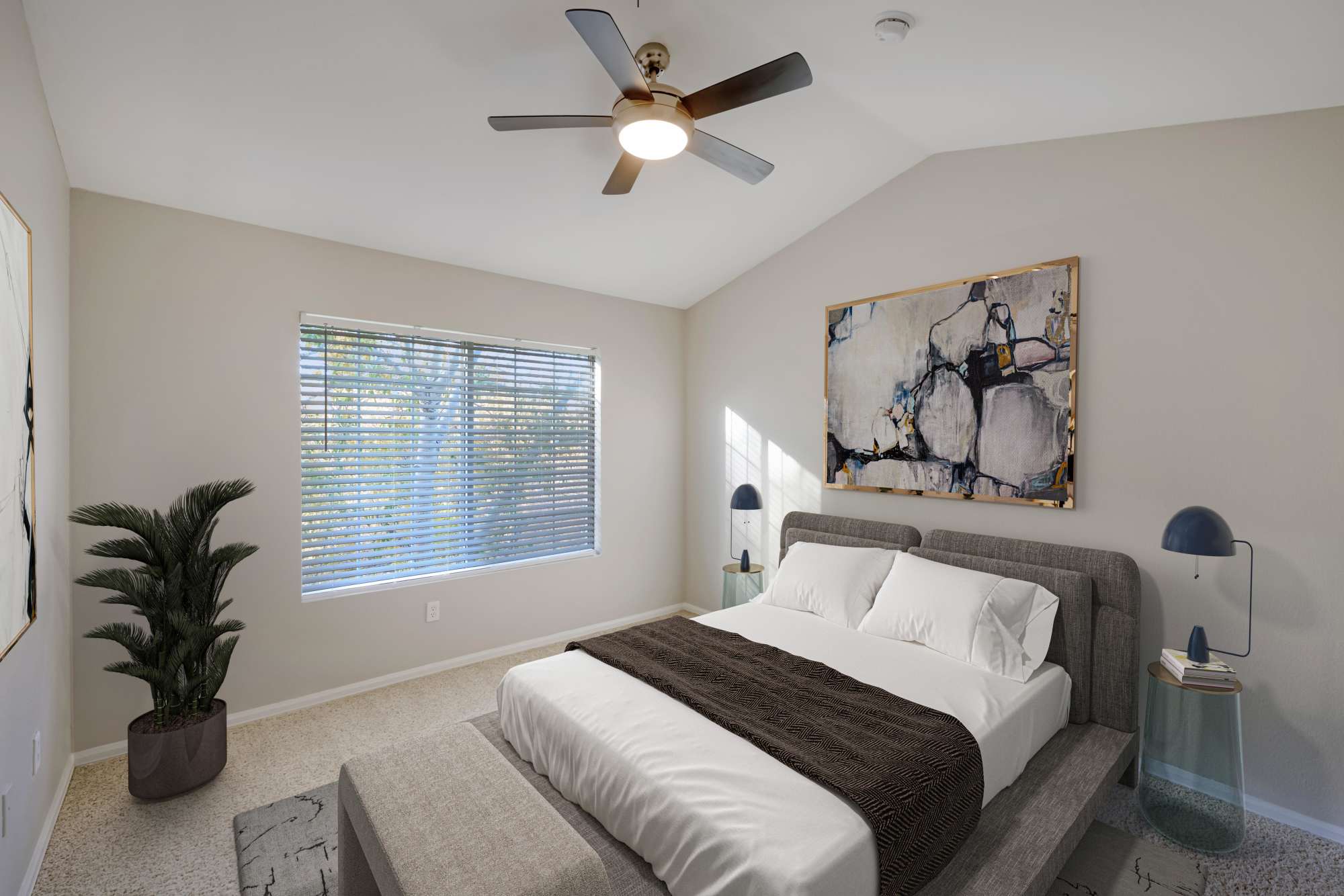 A spacious master bedroom with a ceiling fan at The Crossings at Bear Creek Apartments in Lakewood, Colorado
