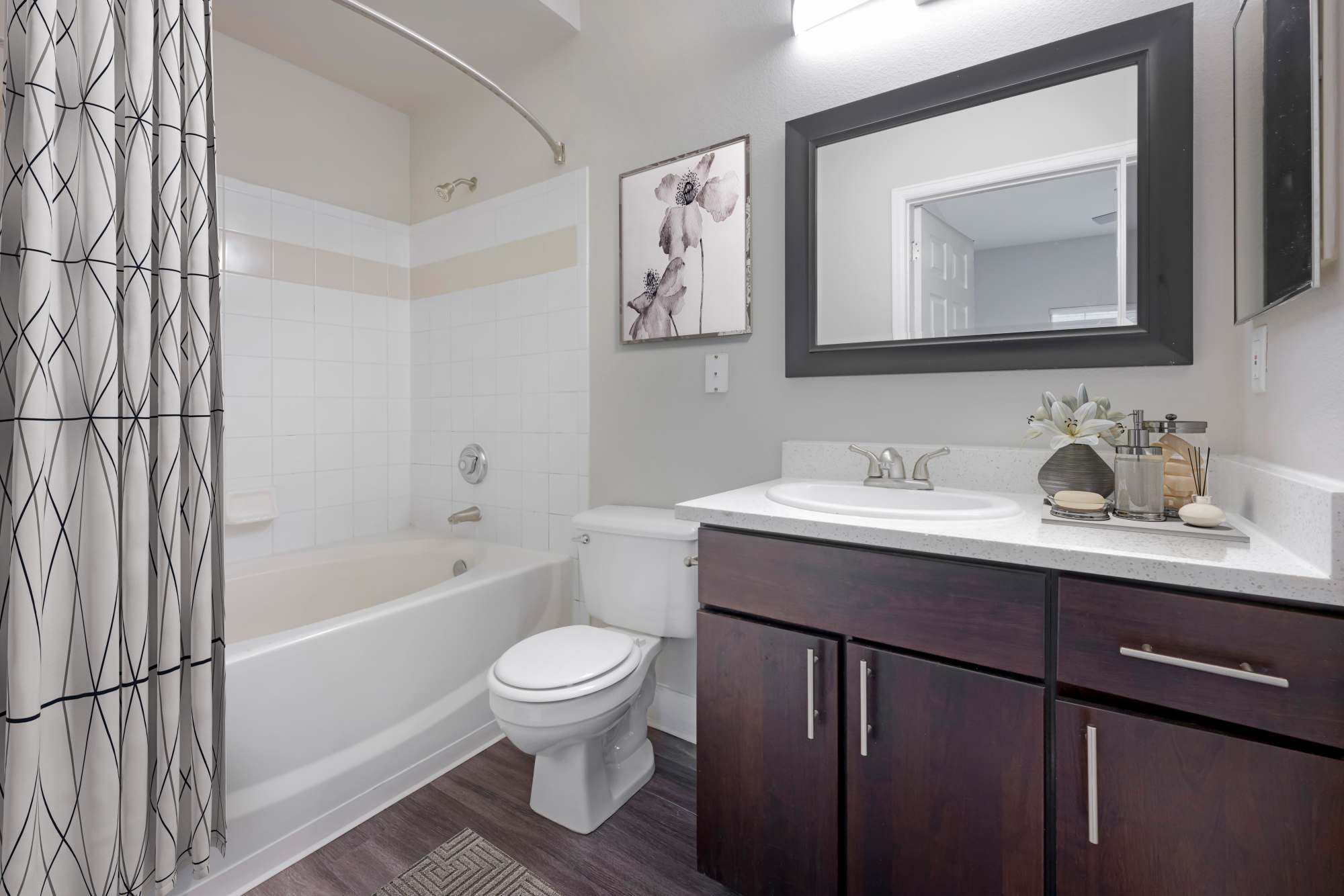 A bathroom with a bathtub at The Crossings at Bear Creek Apartments in Lakewood, Colorado