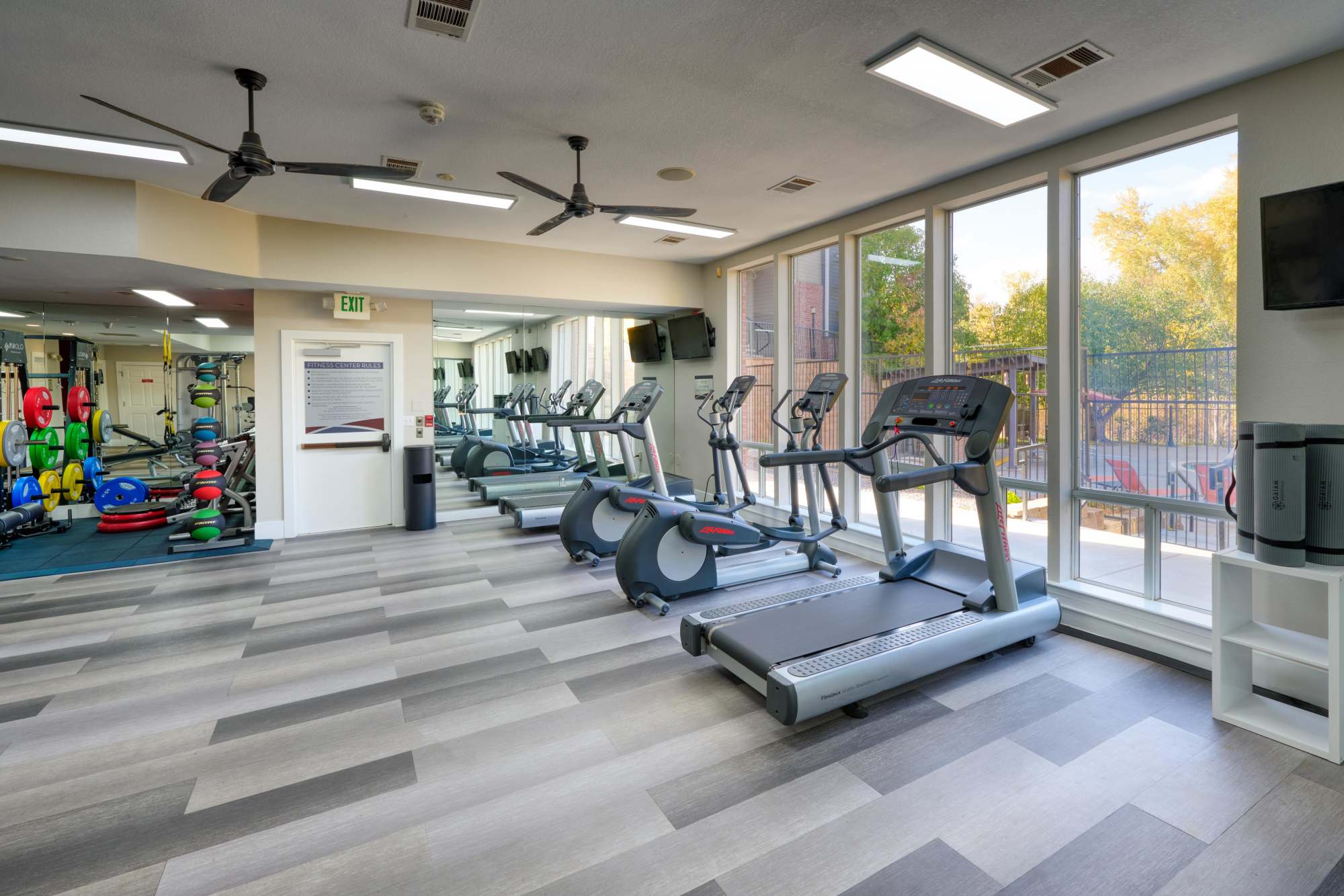 Clean, modern community gym with Cardio Machines at The Crossings at Bear Creek Apartments in Lakewood, Colorado