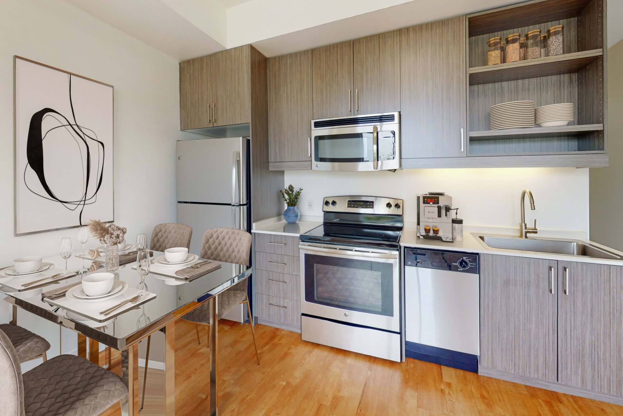A kitchen with stainless-steel appliances, refrigerator, wooden cabinets at The Union in Portland, Oregon