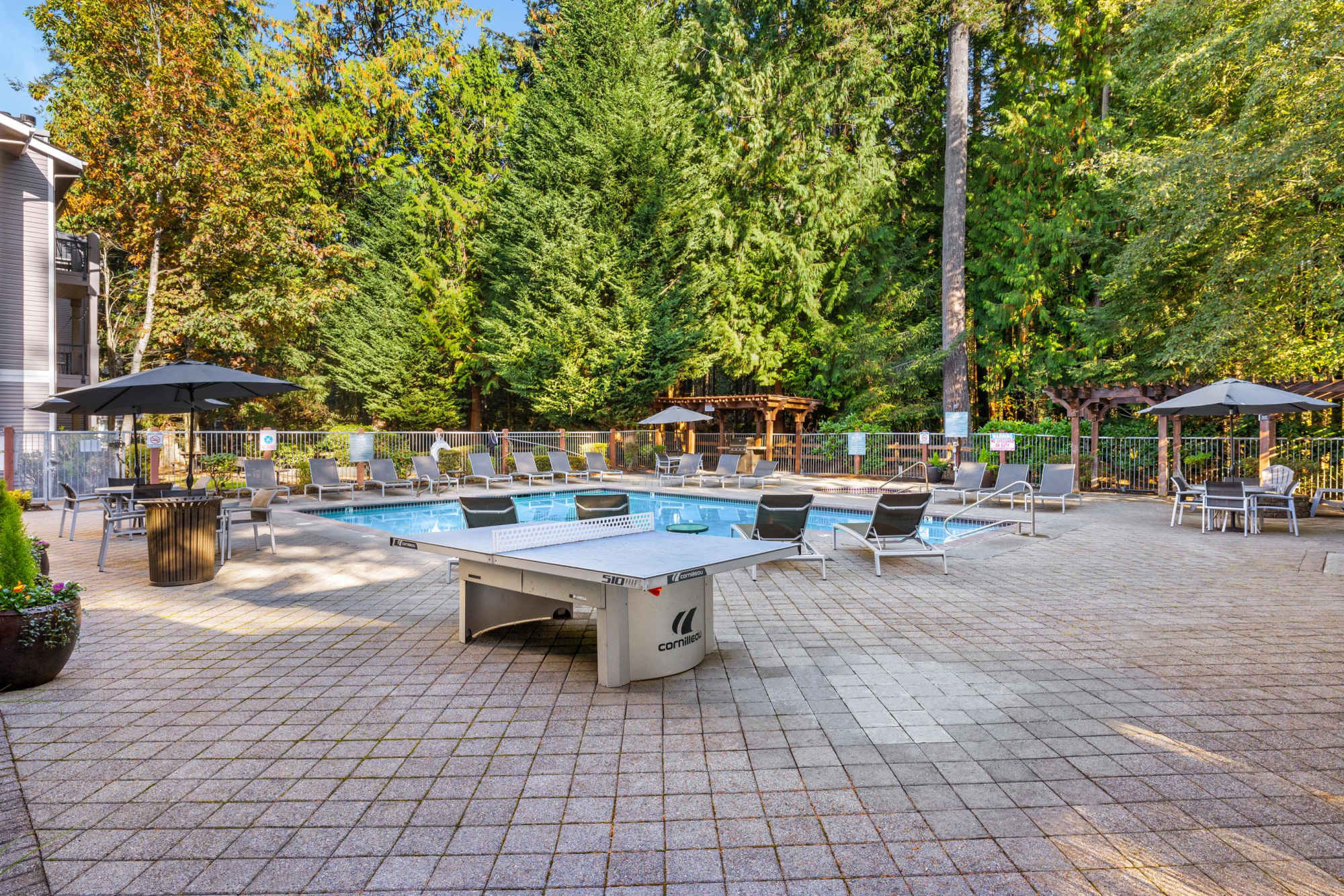 A ping pong table by the pool at Wildreed Apartments in Everett, Washington