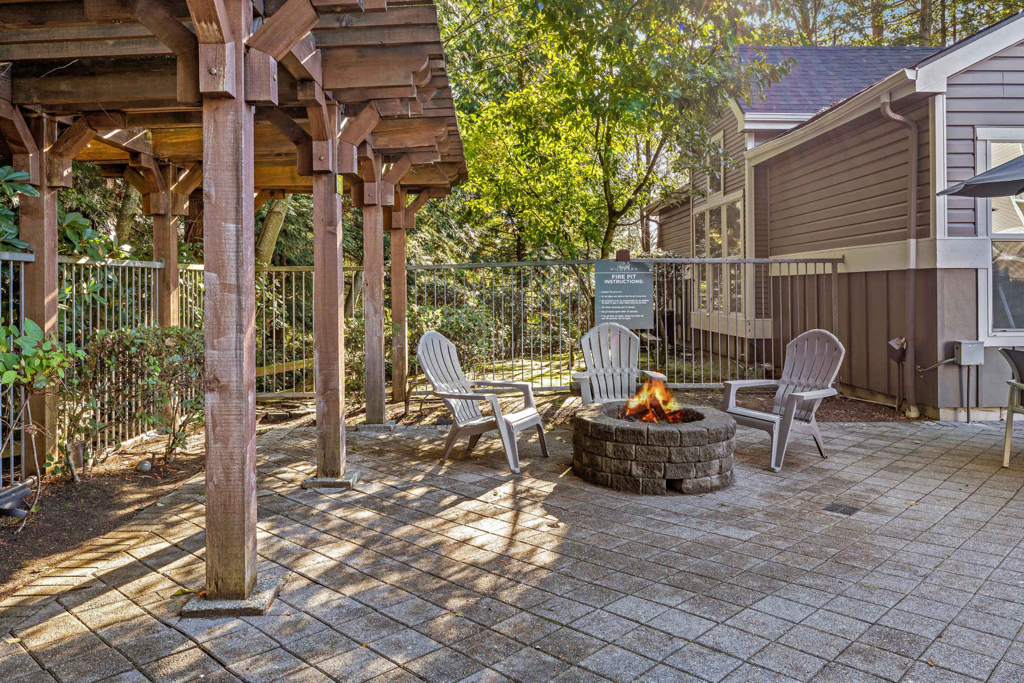 Fire pit lounge area near the pool at Wildreed Apartments in Everett, Washington