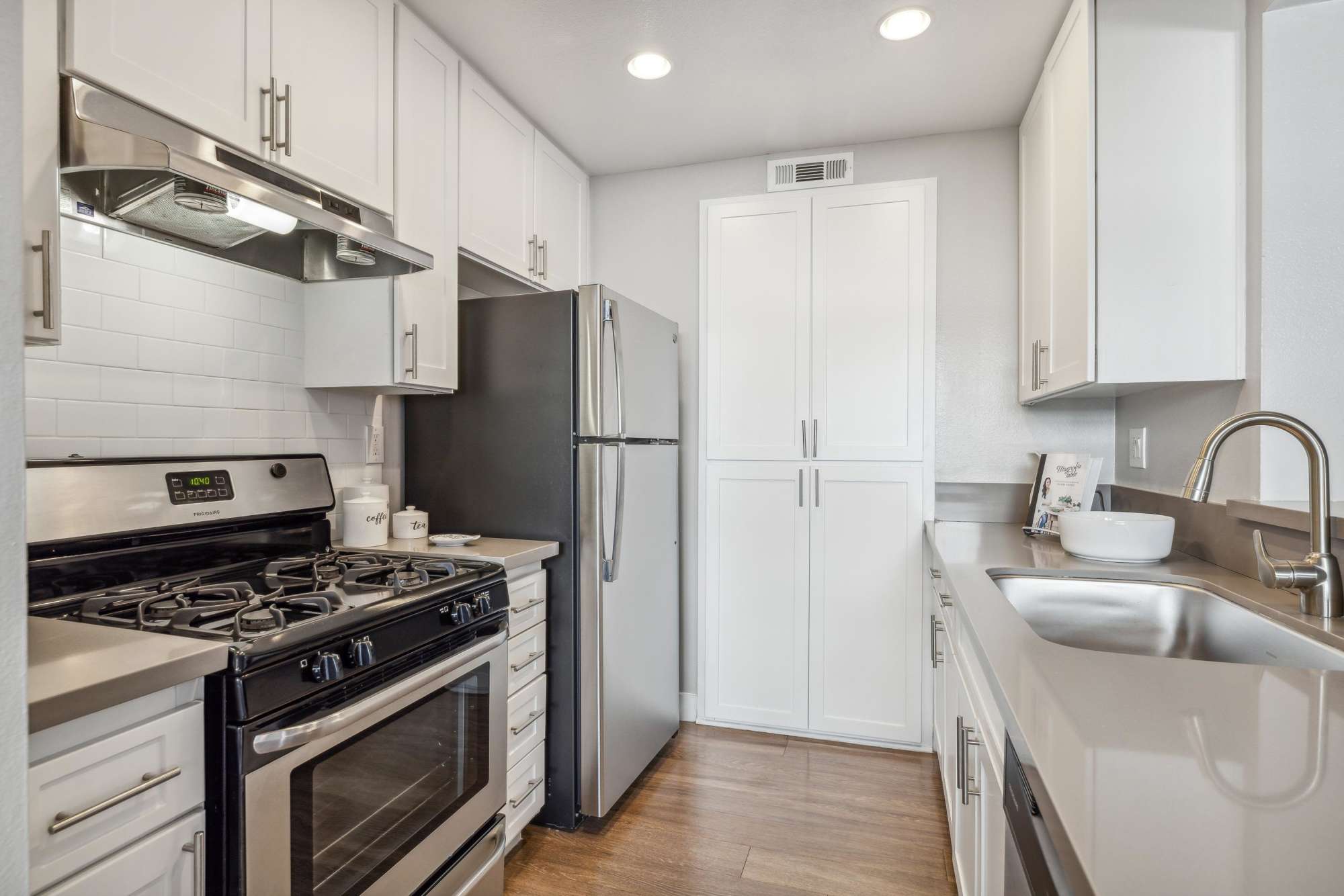A kitchen with stainless-steel appliances at Portofino Townhomes in Wilmington, California