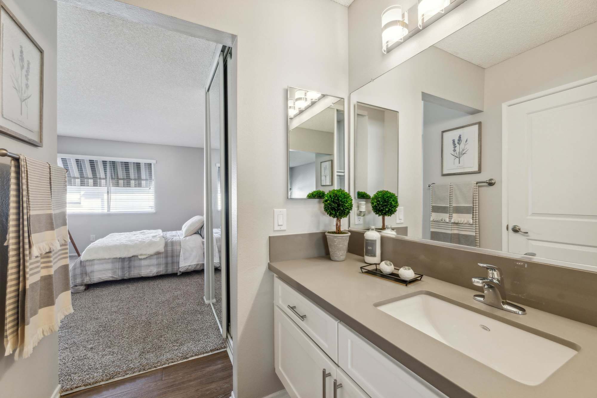 A townhome bathroom with wood-style flooring at Portofino Townhomes in Wilmington, California