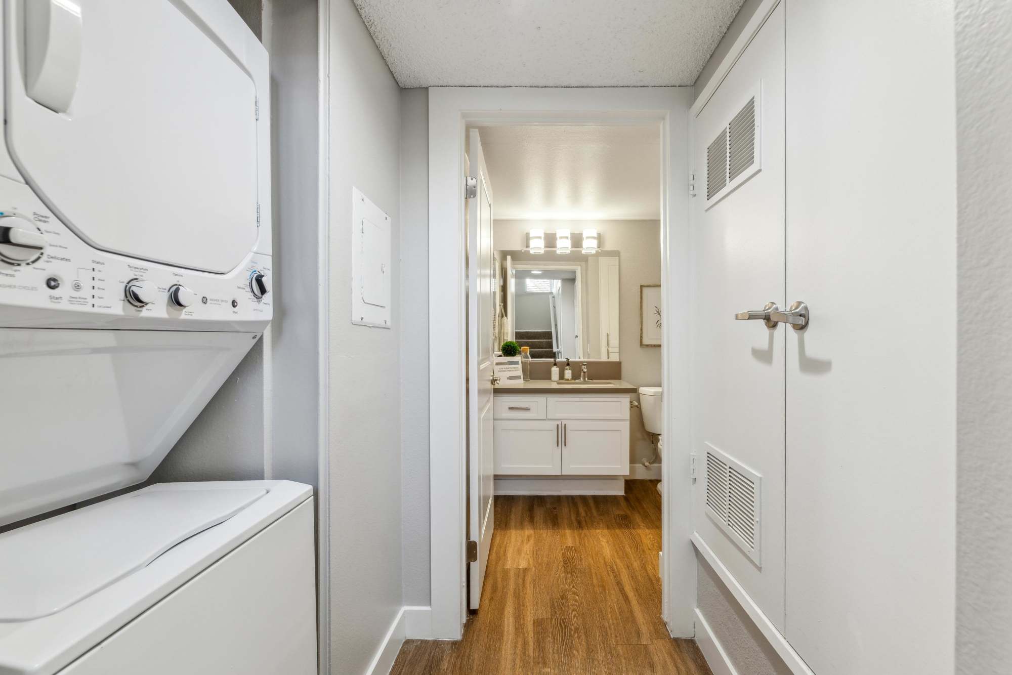 A washer and dryer in a townhome hallway at Portofino Townhomes in Wilmington, California