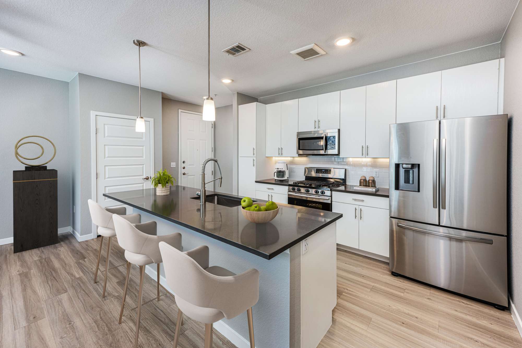 An open kitchen with expansive counter space at Hawthorne Hill Apartments in Thornton, Colorado