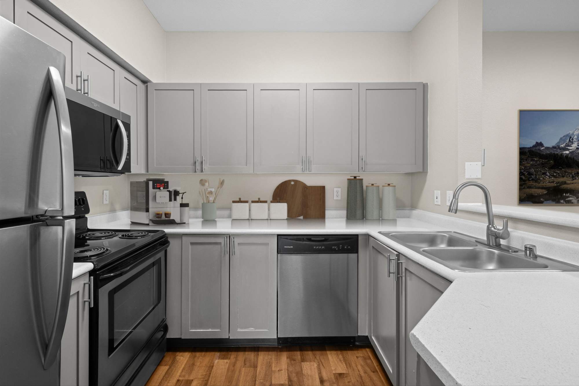 Brown Renovated Kitchen with White Quartz Counters at Wildreed Apartments in Everett, Washington