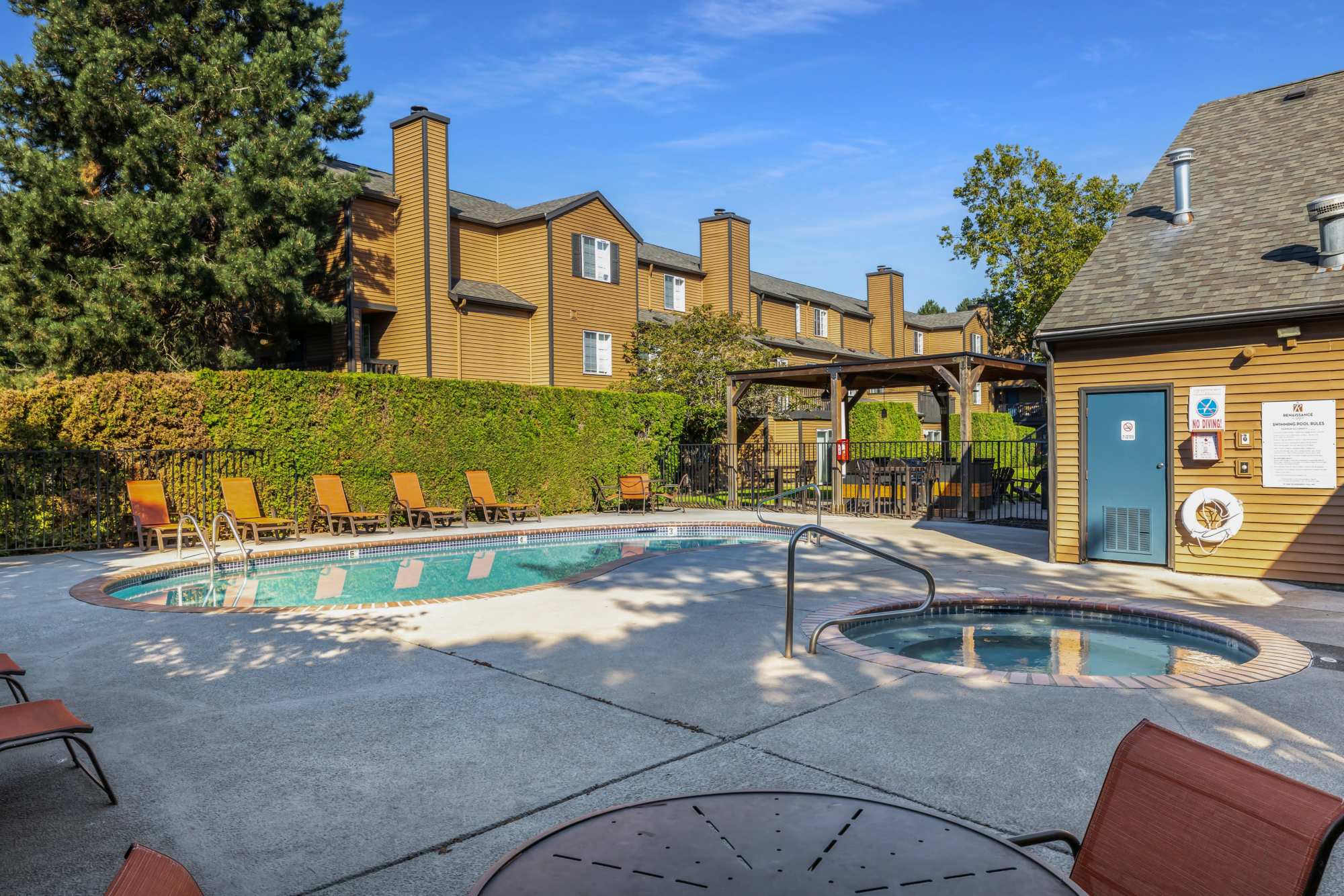 Community pool with lounge chairs at Renaissance at 29th Apartments in Vancouver,Washington