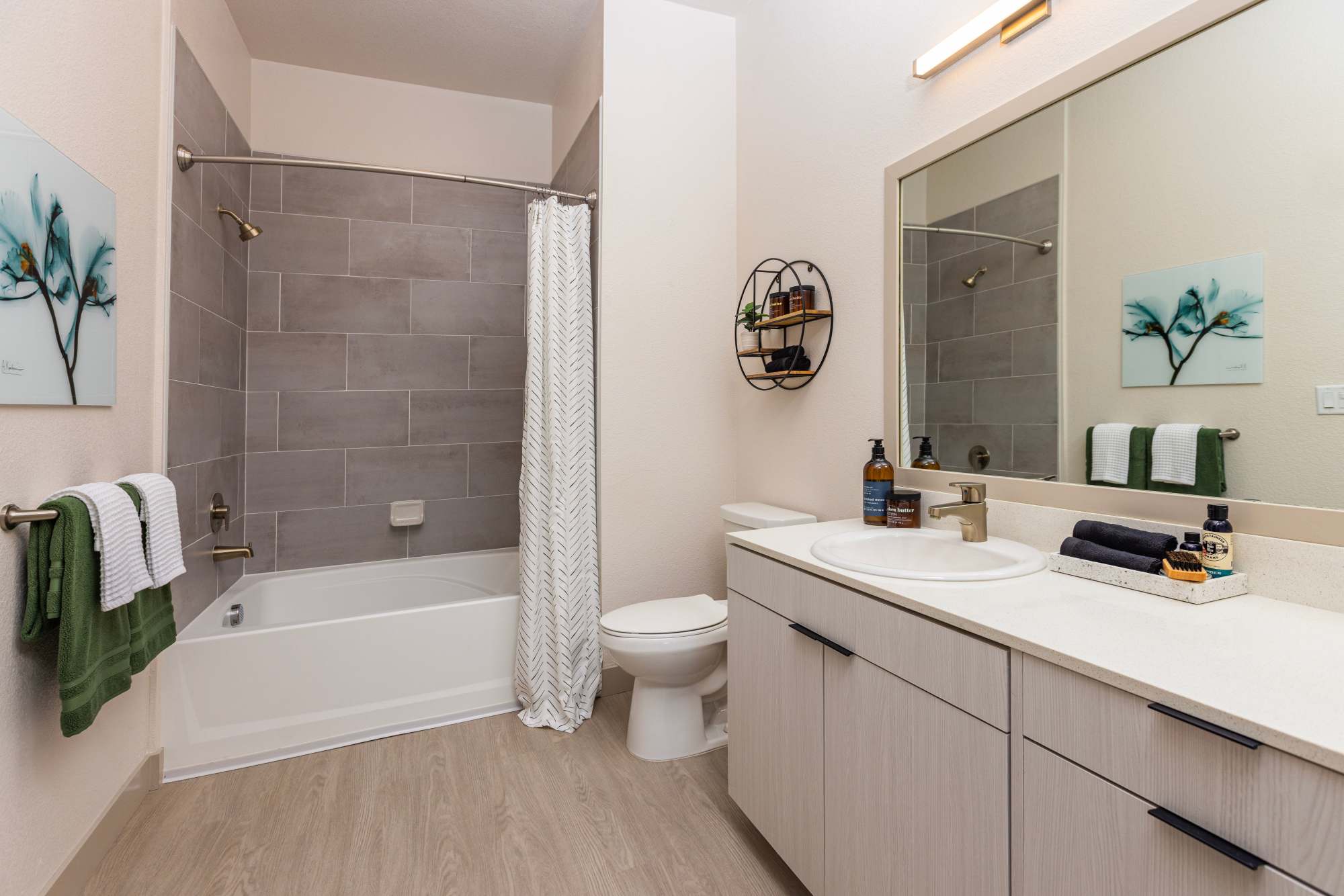 Bright bathroom with shower and tub at Zeta Luxury Apartments in Sacramento, California