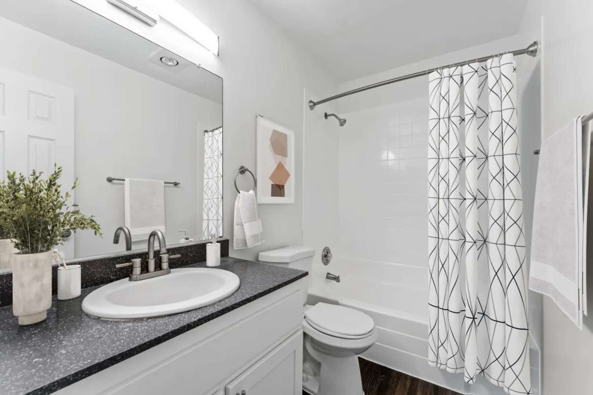 Bathroom with frameless vanity mirror at Shadow Ridge Apartments in Oceanside, California 